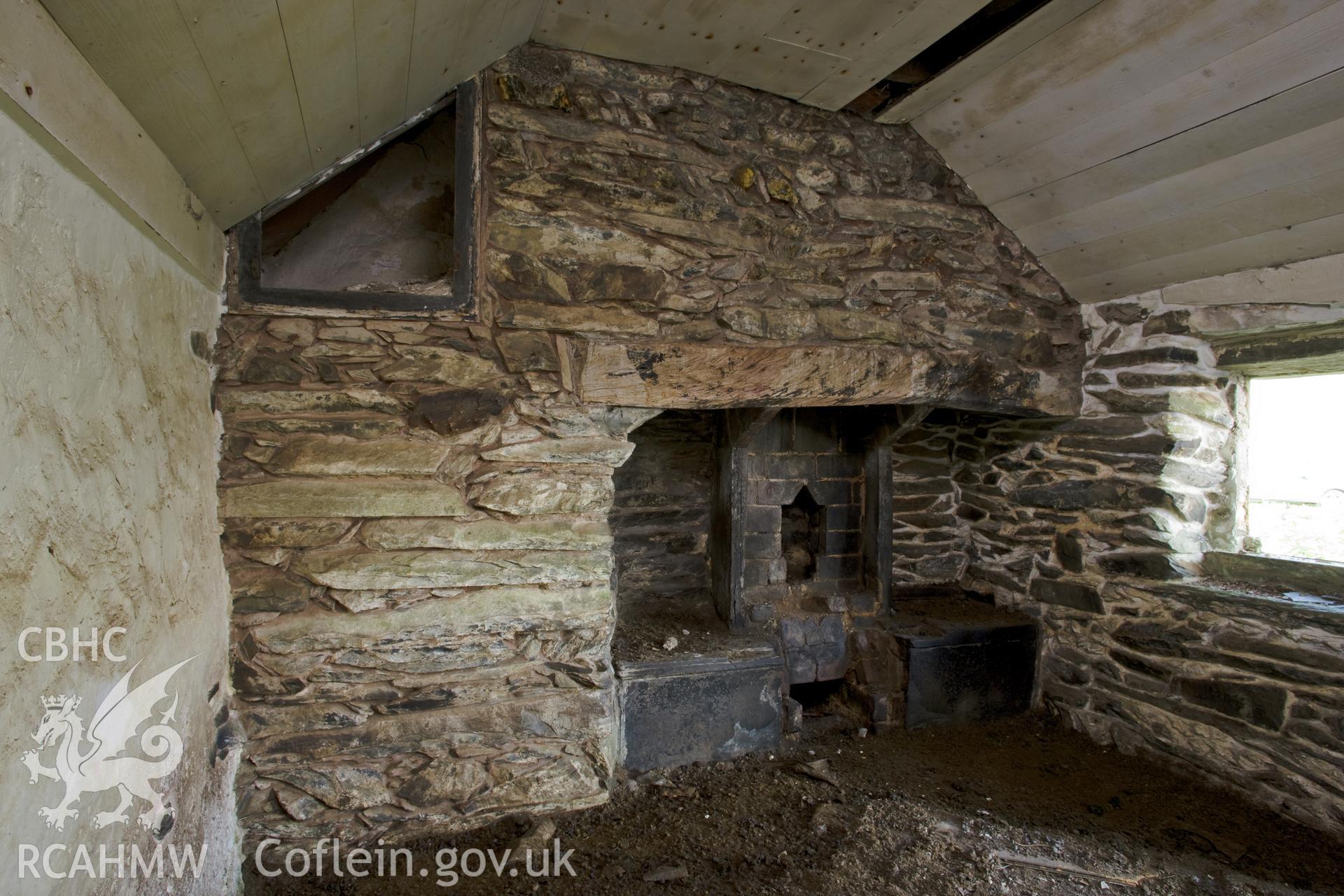 Interior of left-hand room with fireplace and bread oven.