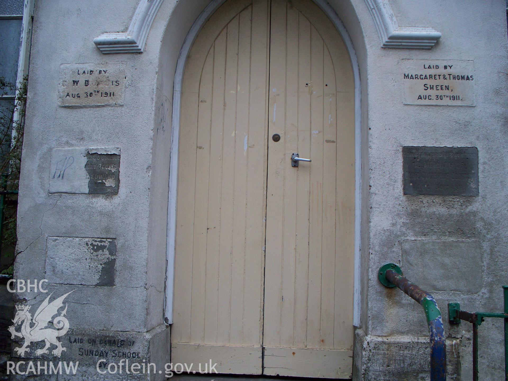 Foundation stones flanking entrance door N gable.