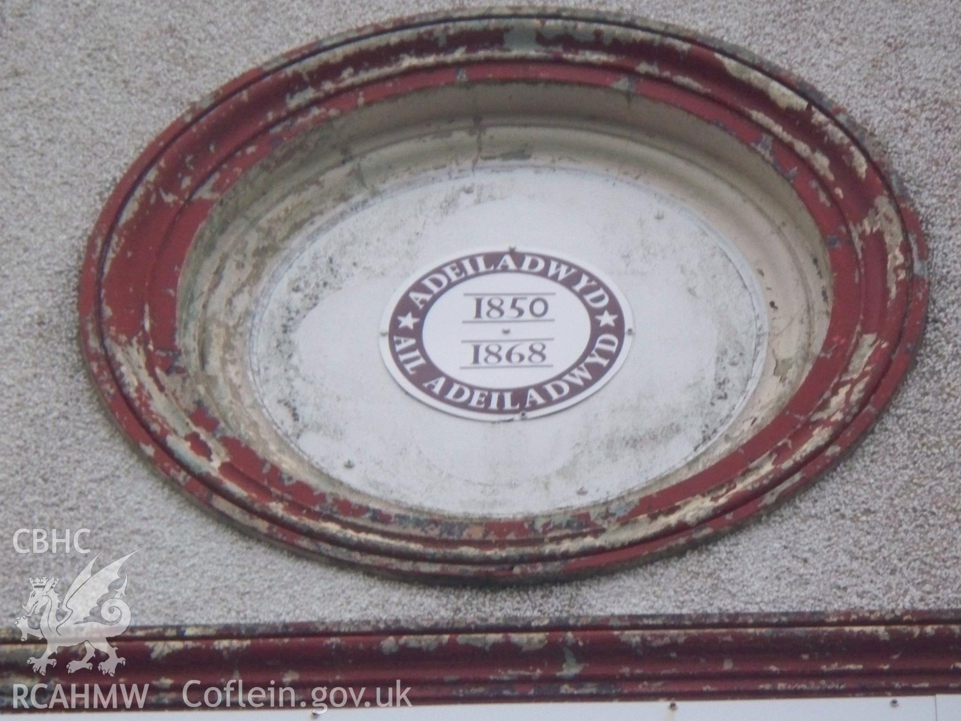 Roundel in gable with built 1850, rebuilt 1868 printed on plastic (in Welsh).