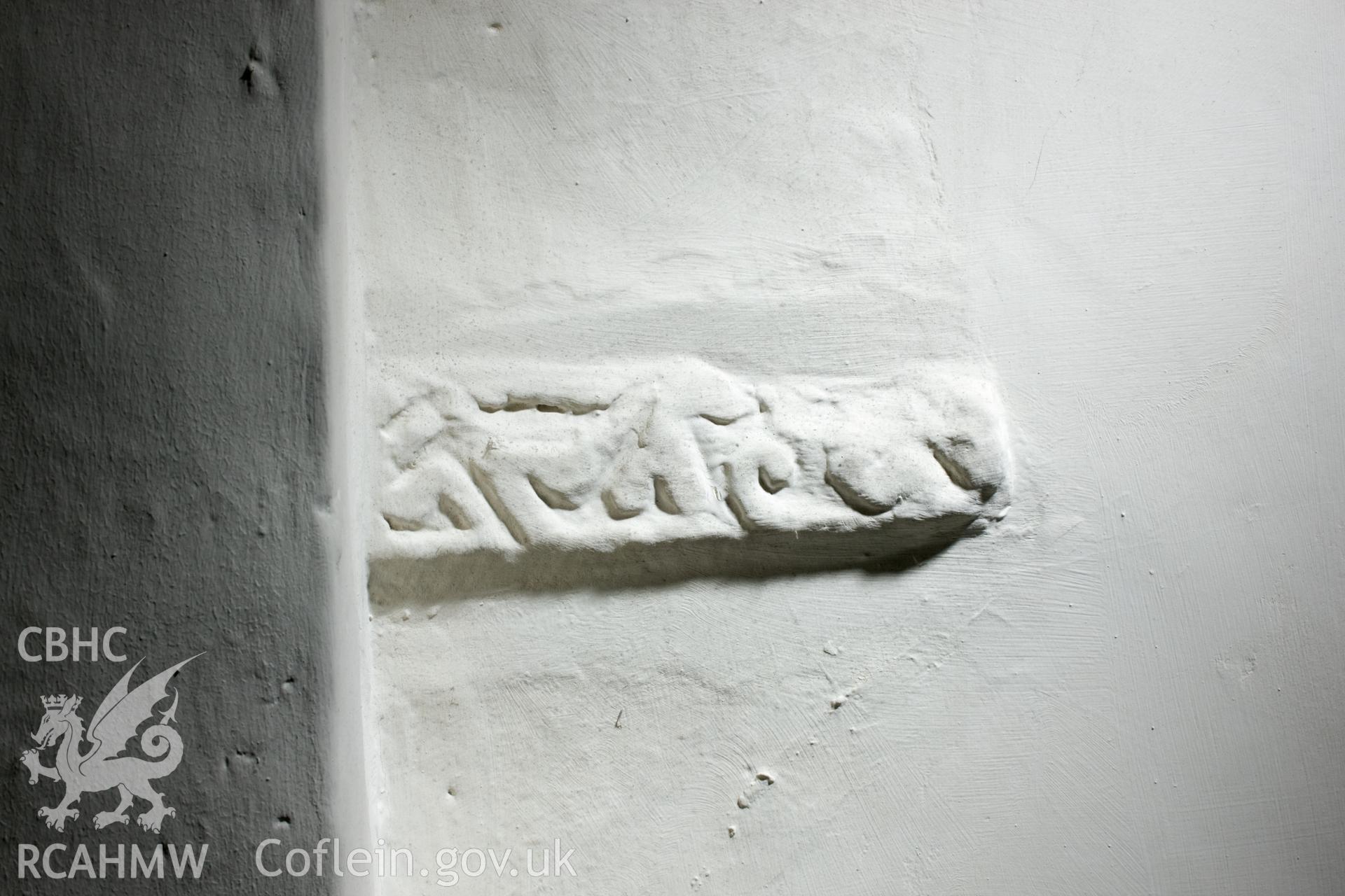 Early carved stone in interior north wall.