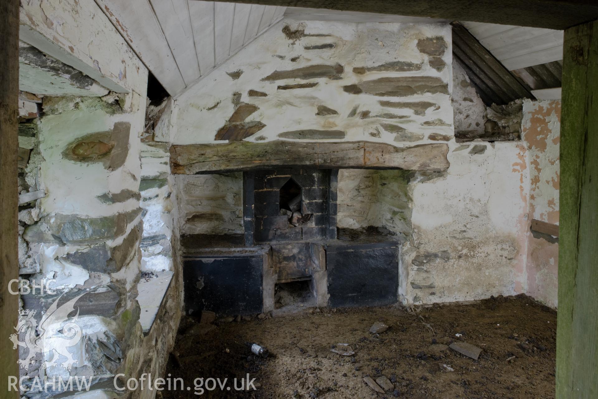 Interior of right-hand room with fireplace.