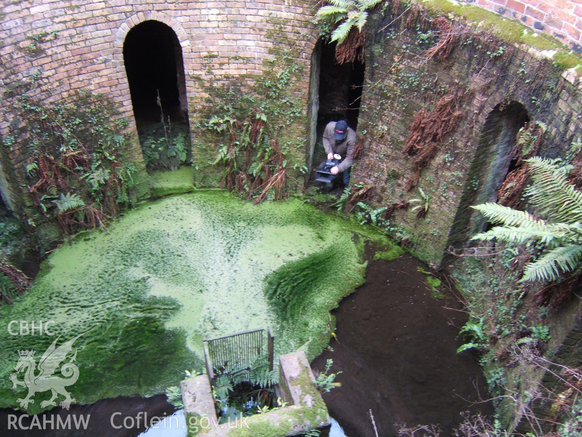 Looking east into slurry well with TV cameraman standing in support vaults.