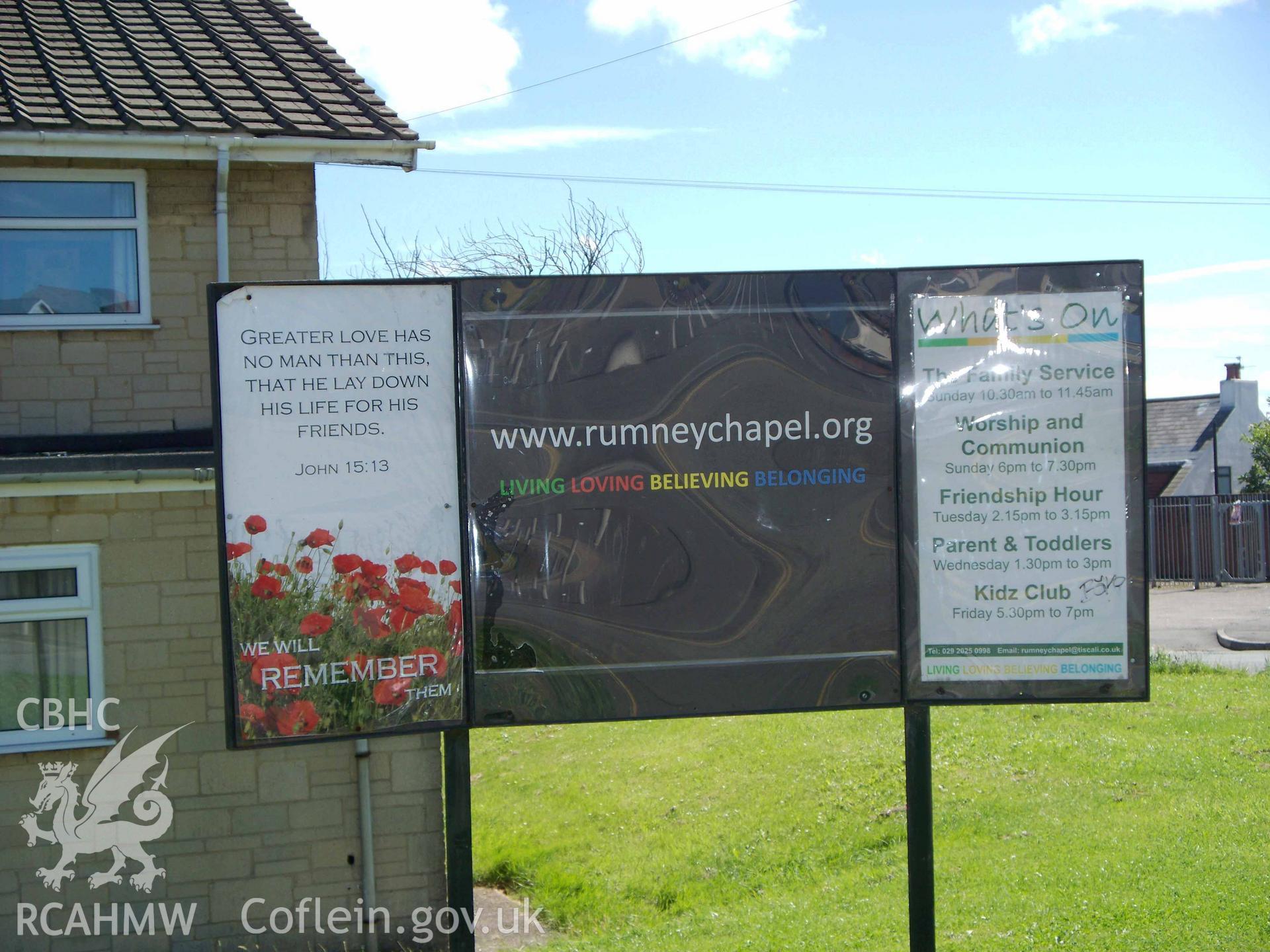 Noticeboard of 'www.rumneychapel.org' on NW side.