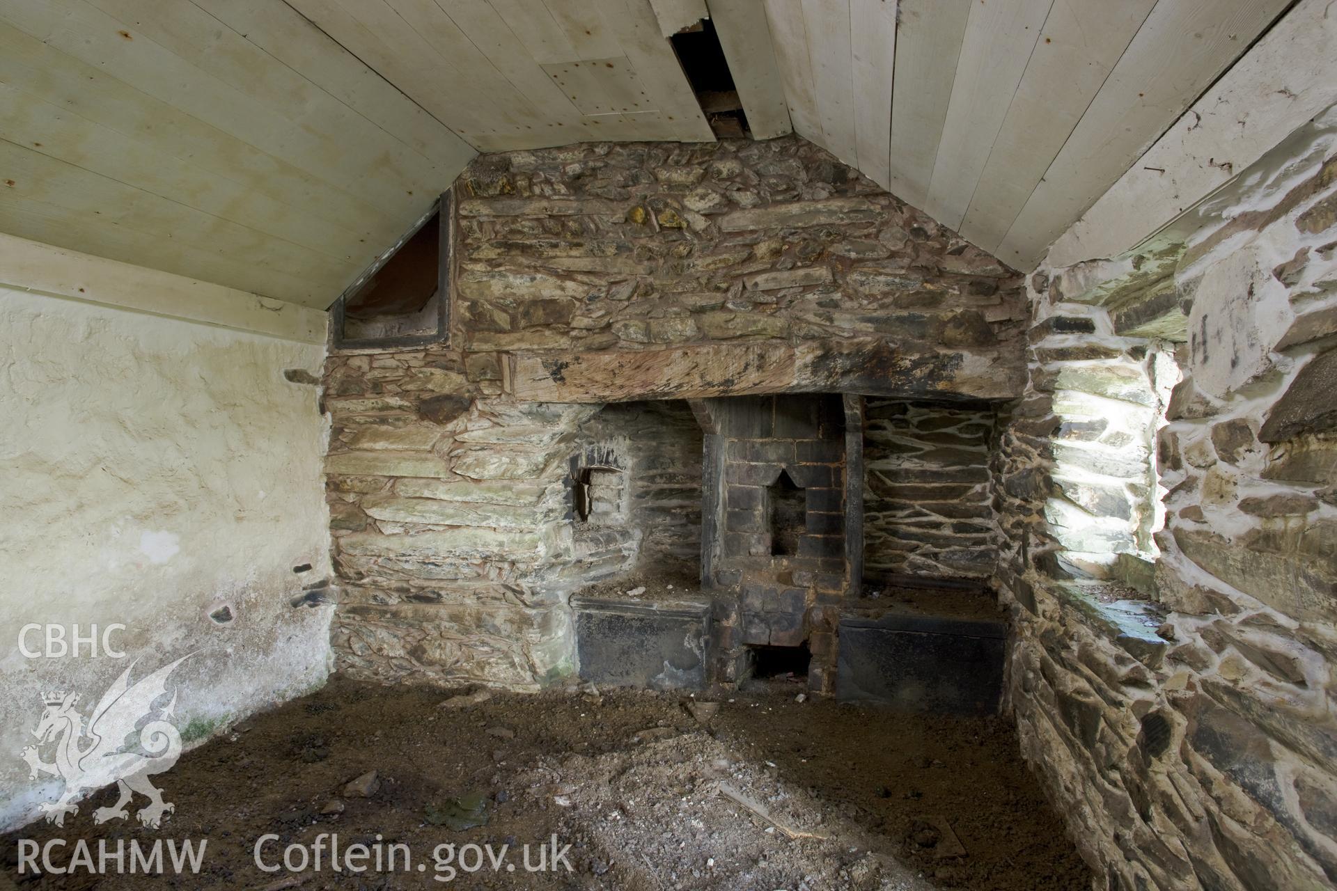 Interior of left-hand room with fireplace and bread oven.