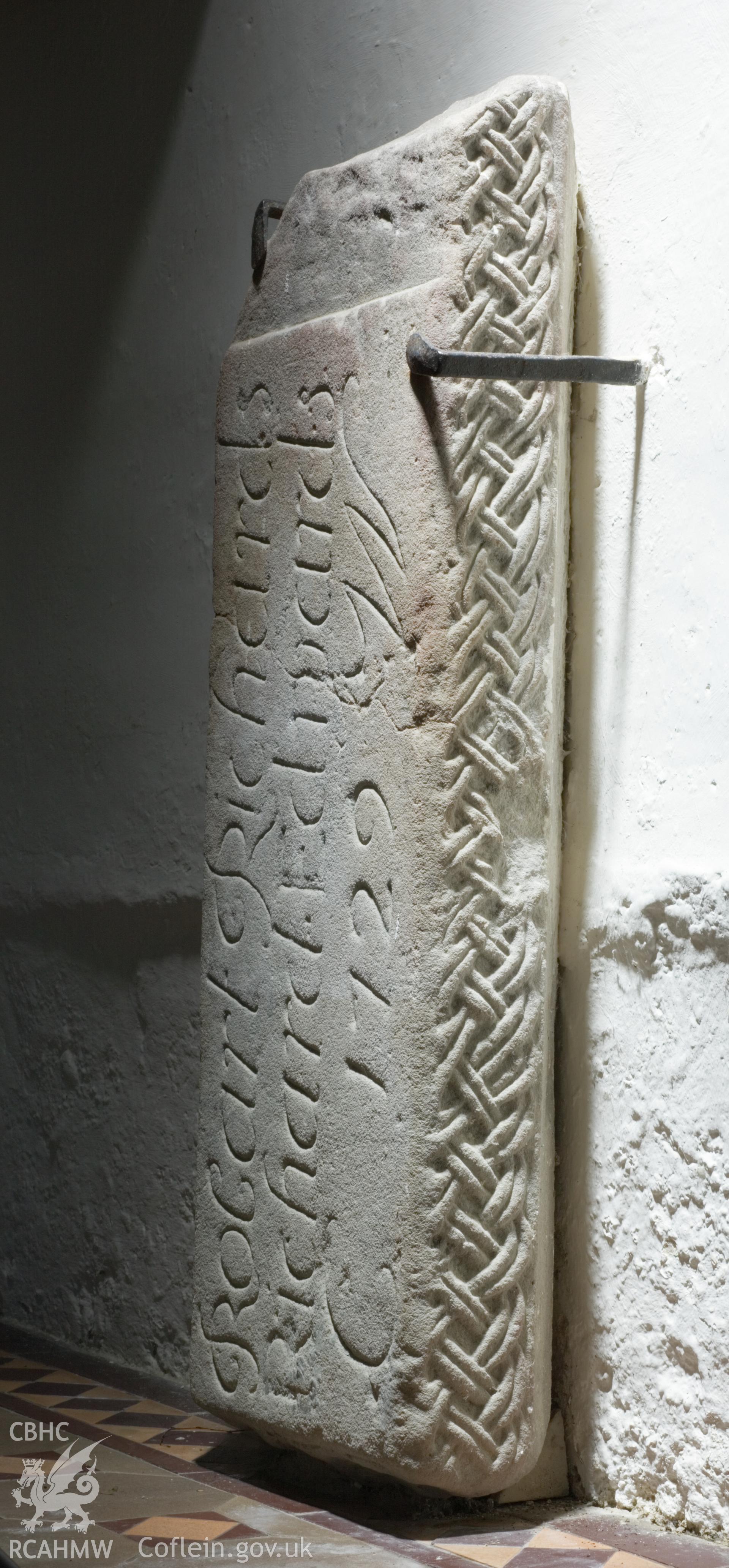Early carved stone in porch, reused as gravestone.