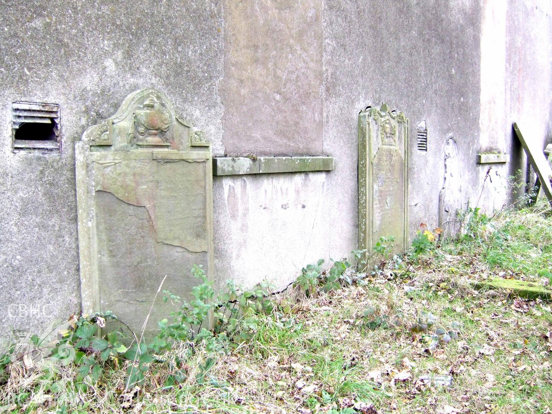 Flaking memorials & blocked lower windows of NE fa?ade.