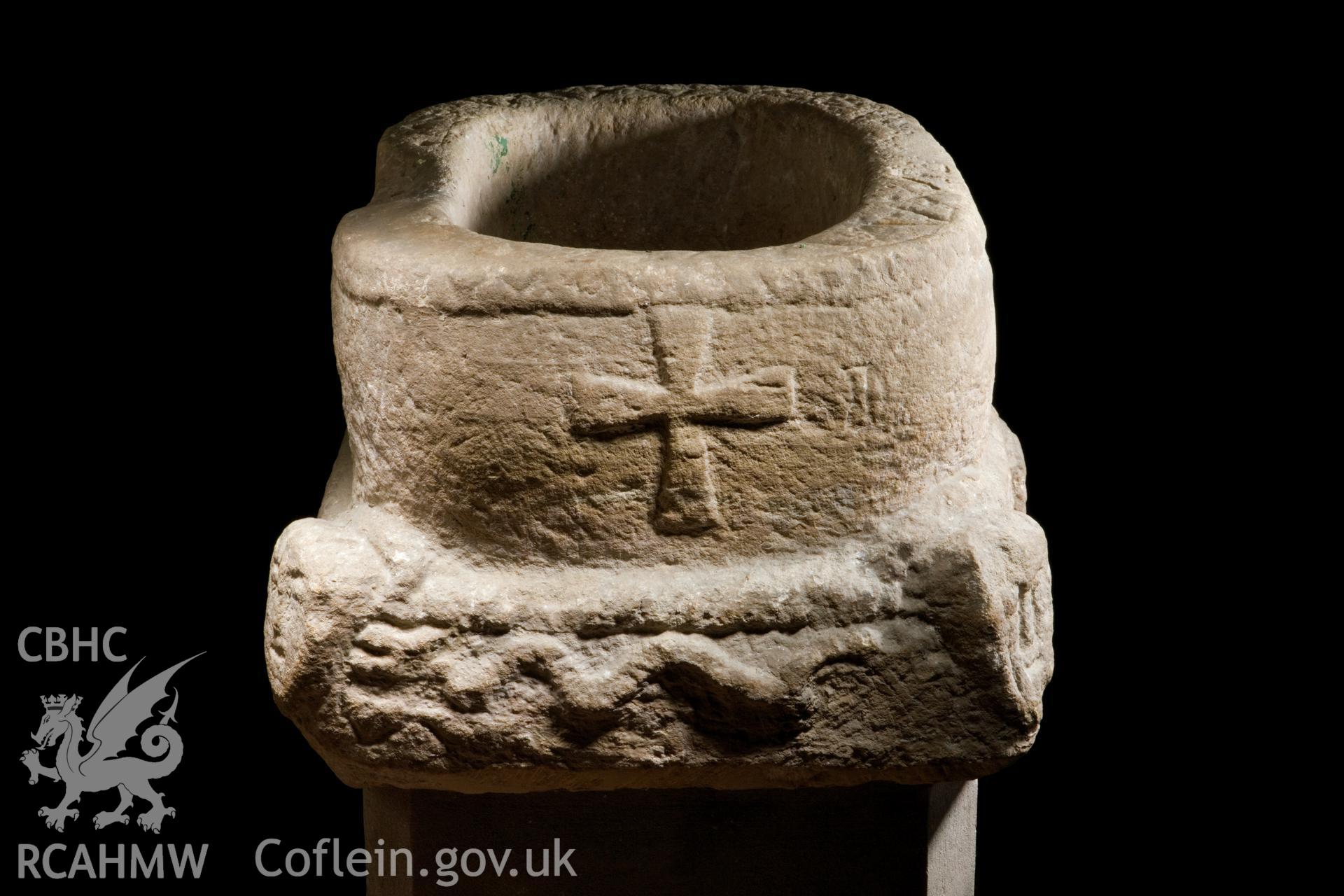 C12th font, cross and serpent, elevated viewpoint.