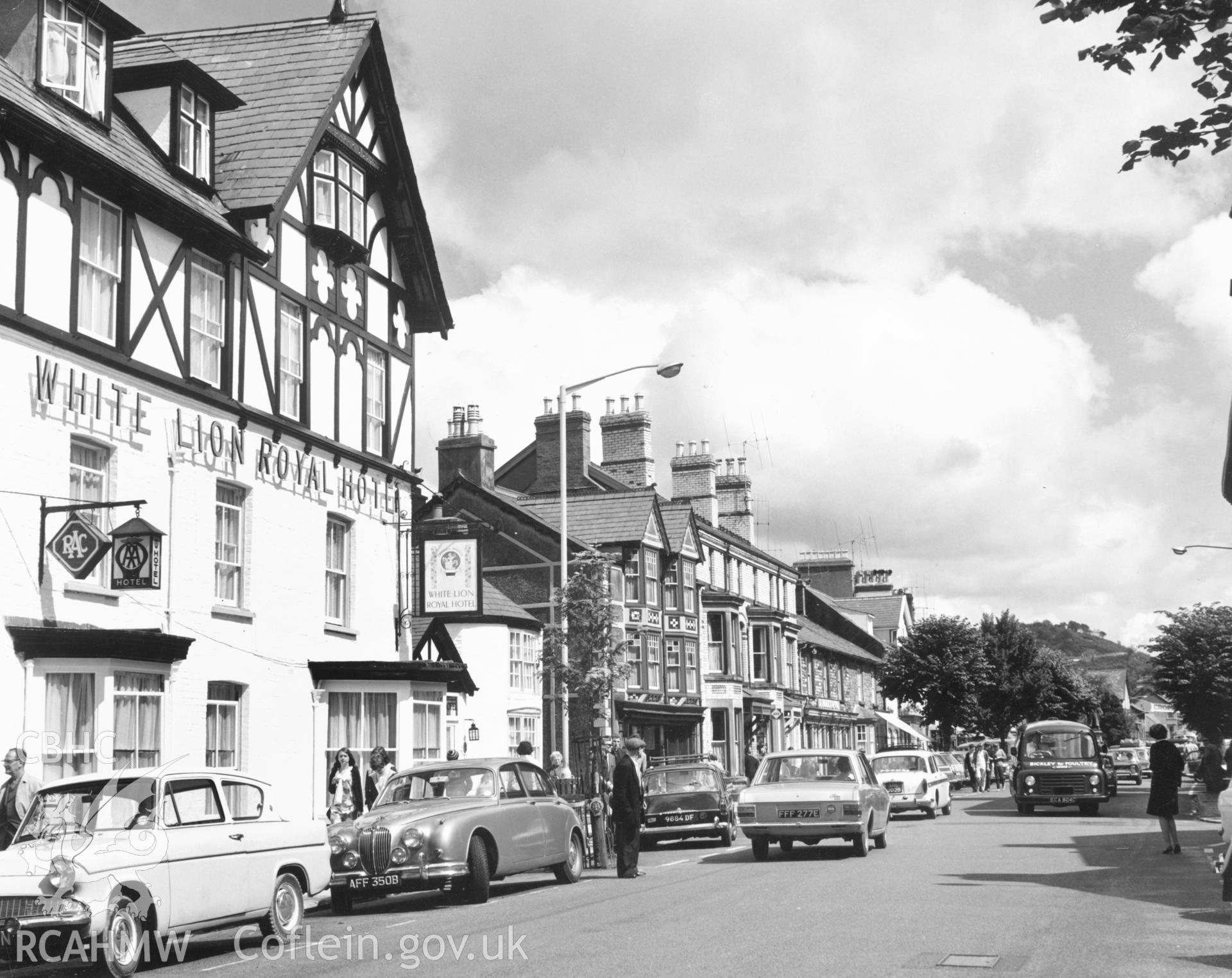 1 b/w print showing view of High Street, Bala with cars and figures; collated by the former Central Office of Information.