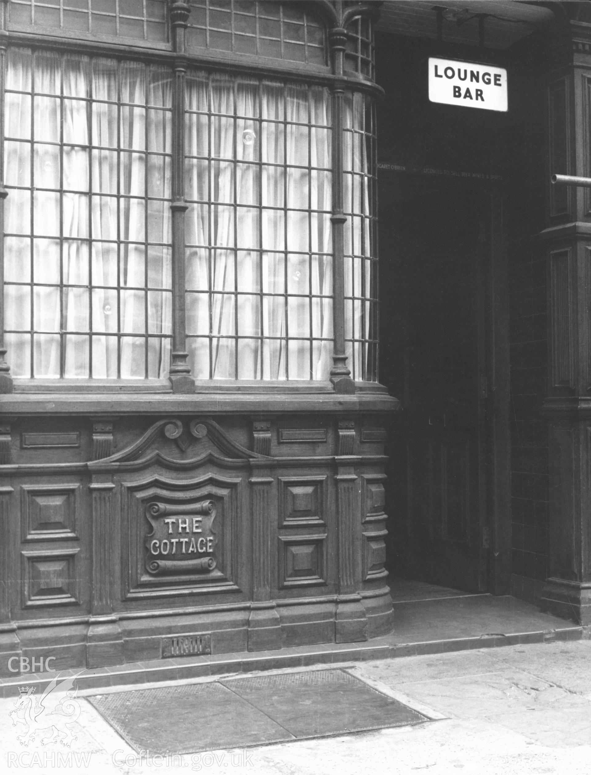 1 b/w print showing doorway of the The Cottage Public House, 25 St Mary Street, Cardiff; collated by the former Central Office of Information.