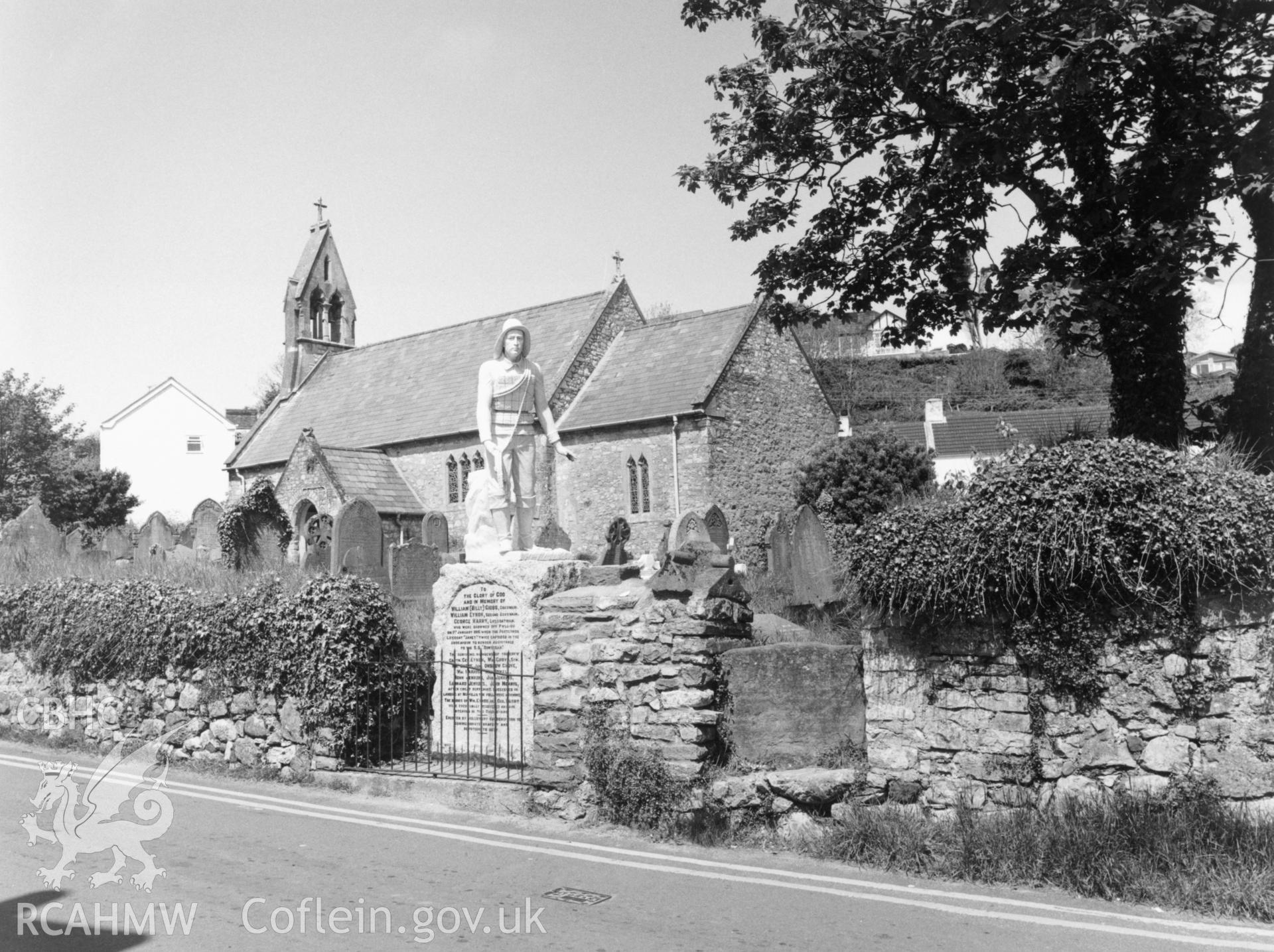 1 b/w print showing view of St Cadoc's Church, Port Eynon, showing RNLI memorial; collated by the former Central Office of Information.