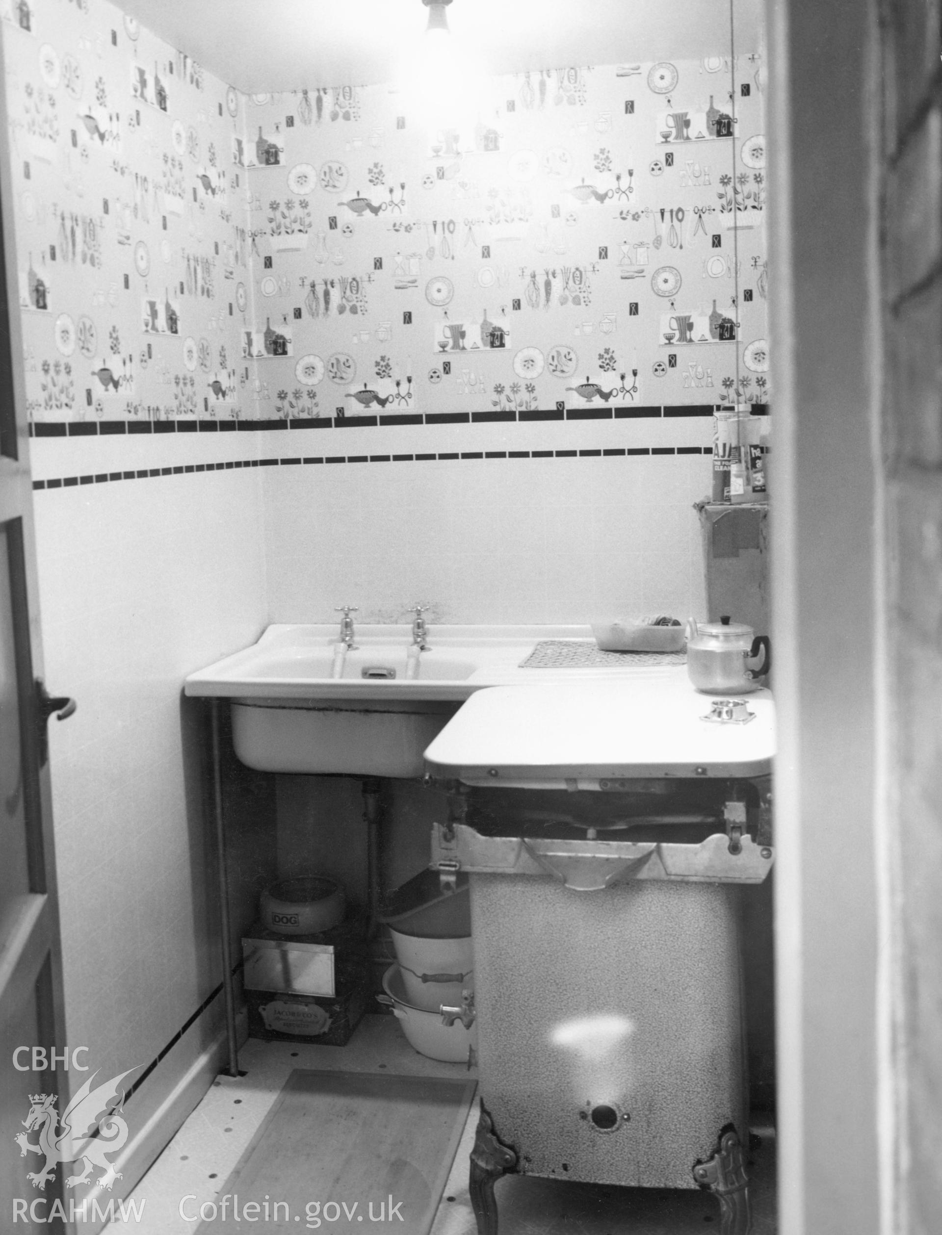 1 b/w print showing interior of a house on Council Street, Ebbw Vale (showing new sink unit), used as an illustration of the Housing Improvement Grant scheme for exhibitions held at Ministry of Housing stands at agricultural shows (1960); collated by the former Central Office of Information.
