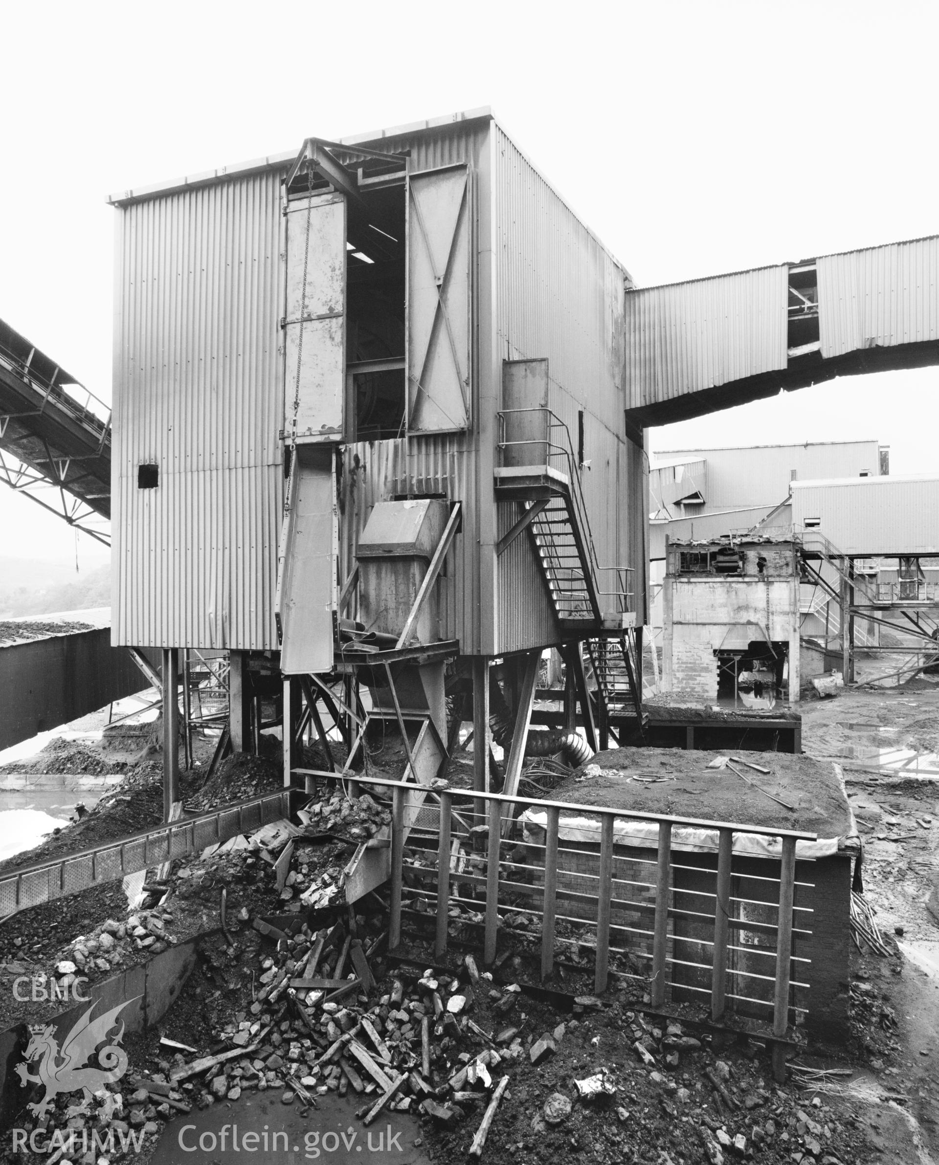 Exterior view showing waste material conveyor