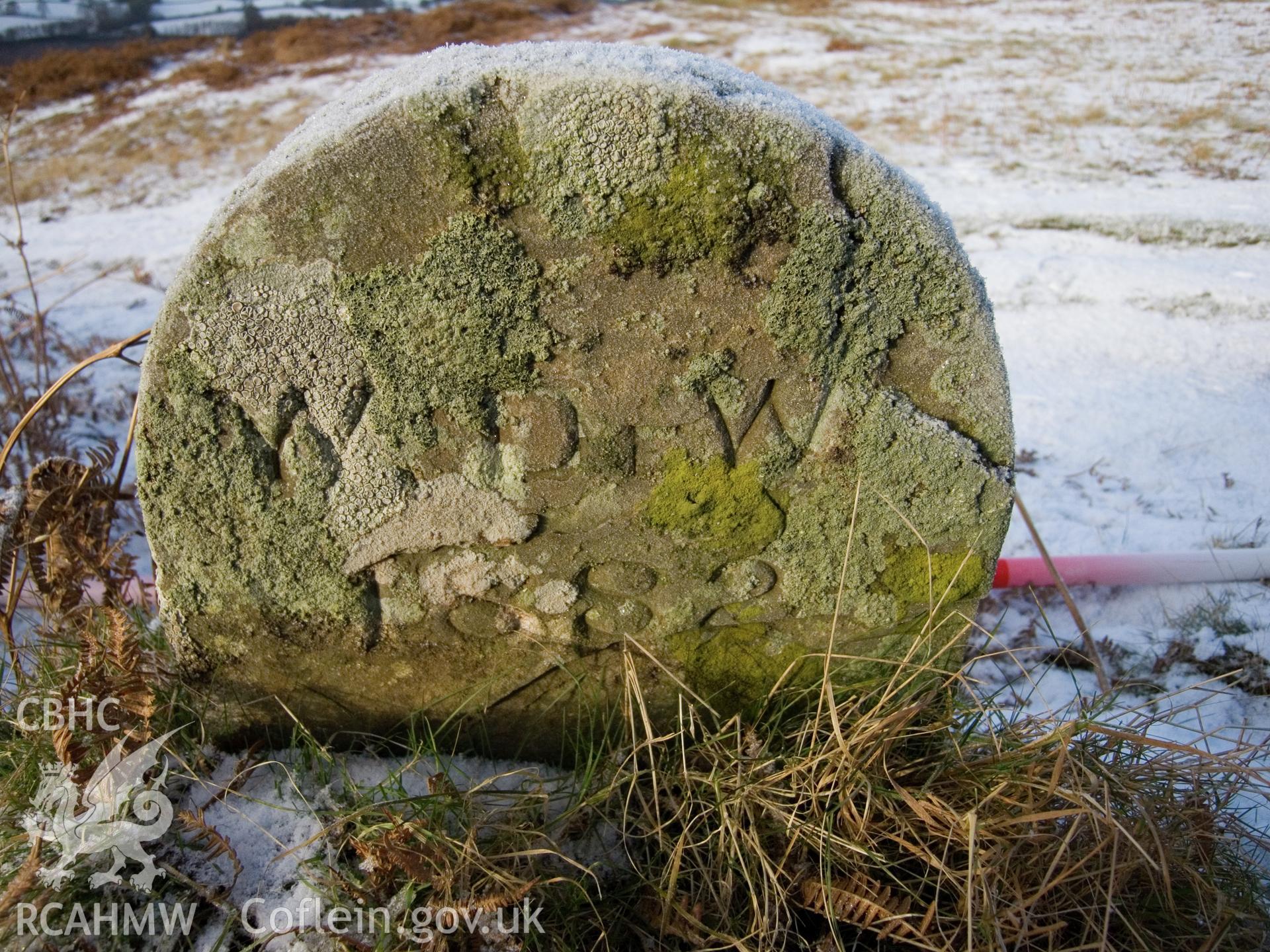 view of E face showing weathered inscription.