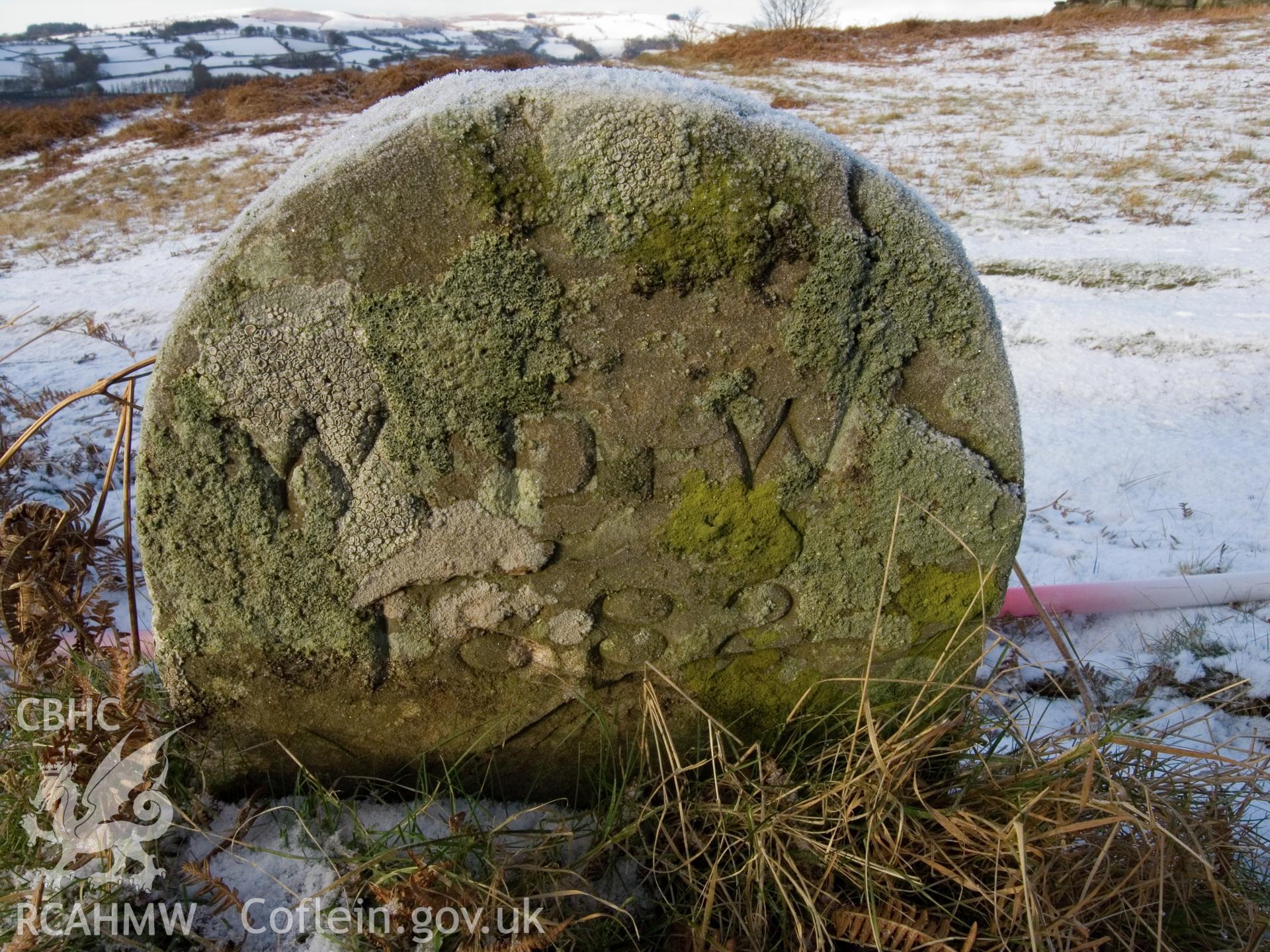 view of E face showing weathered inscription.
