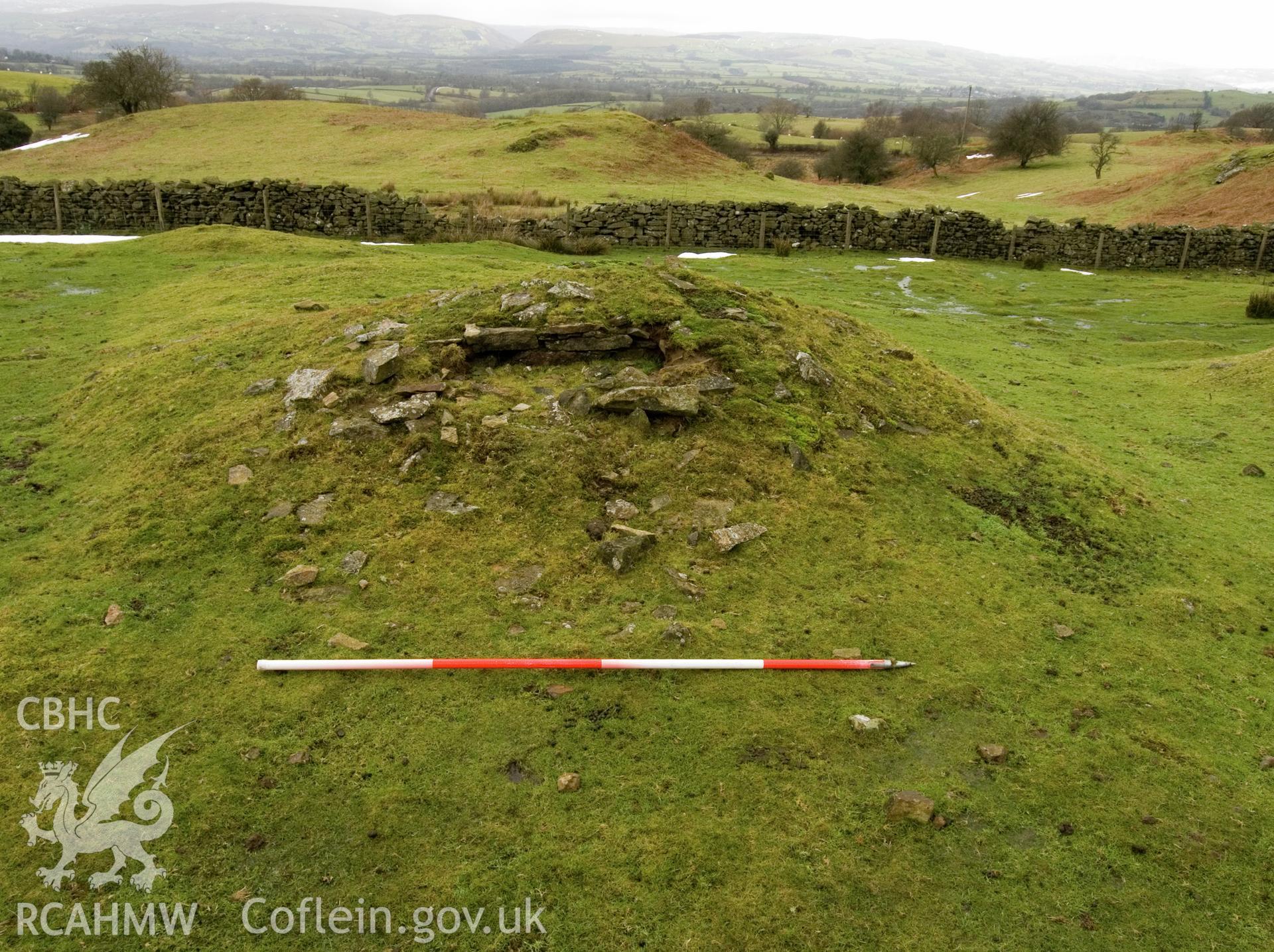 view looking W showing detail of collapsed stone wall.