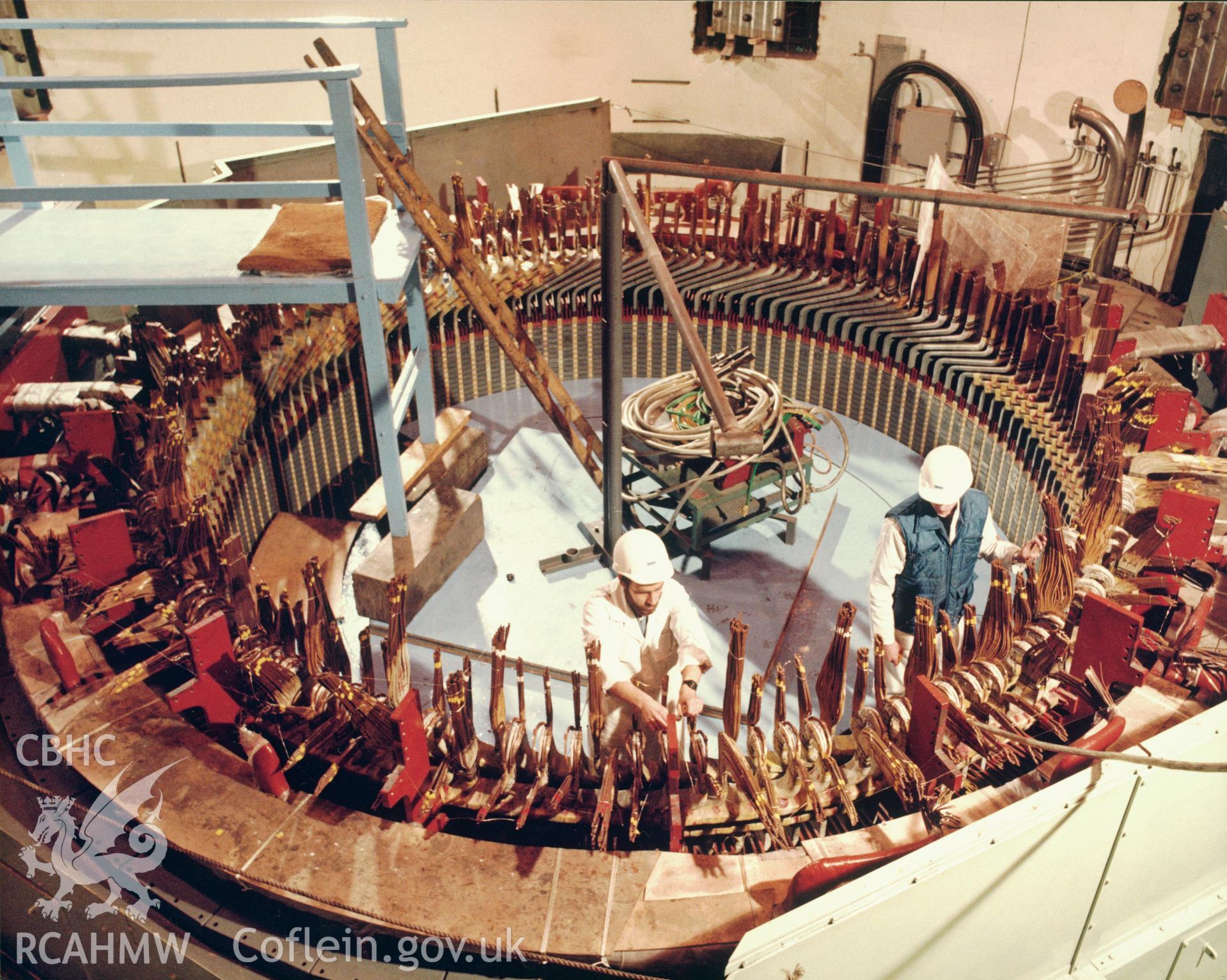 1 colour print showing view of engineers assembling the stator on one of the pump-turbines at Dinorwig Power Station; collated by the former Central Office of Information.