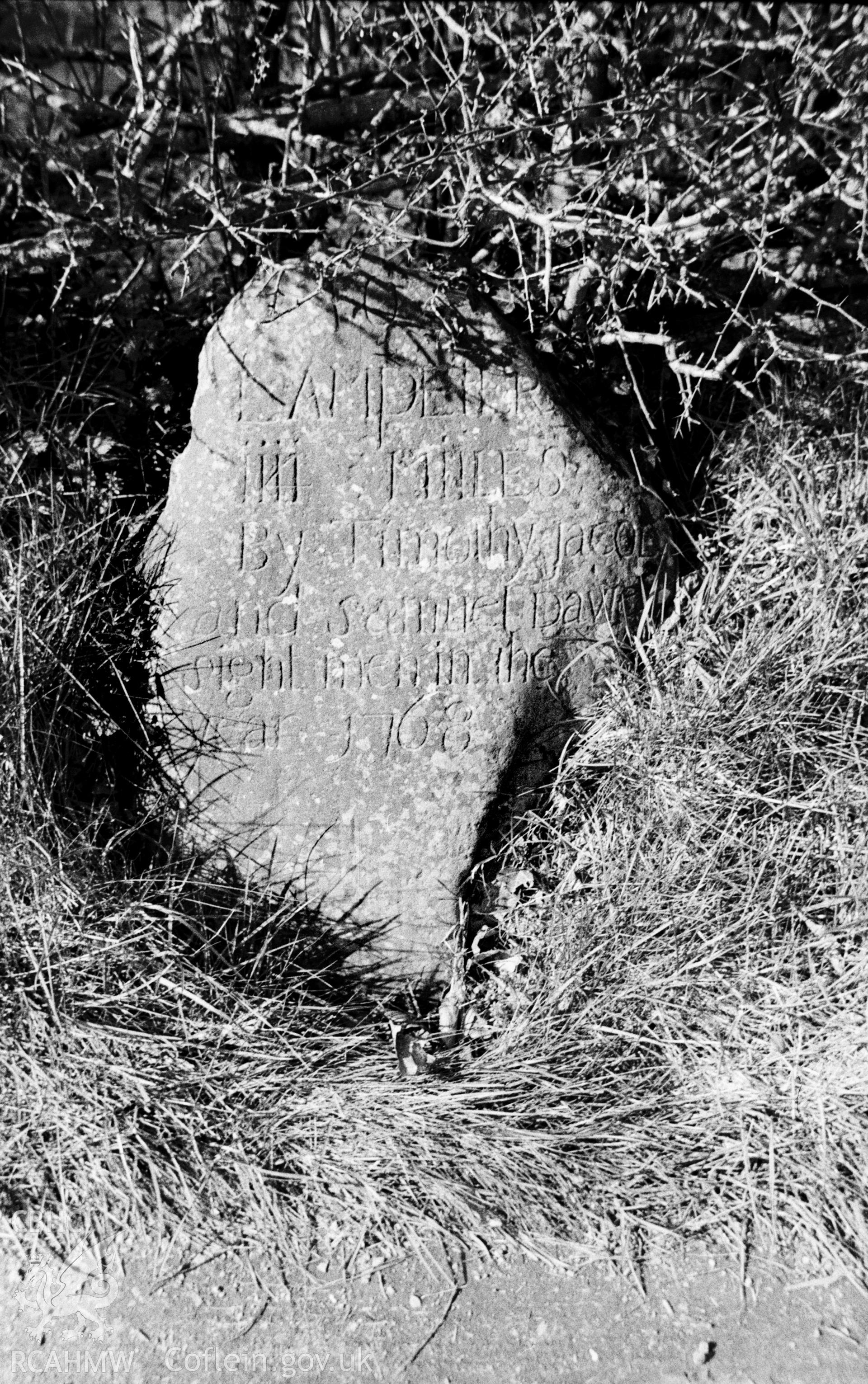 Black and white photograph of a milestone south-west of Llangybi produced by Arthur Chater in 1966, part of a larger collection which has not yet been fully catalogued.