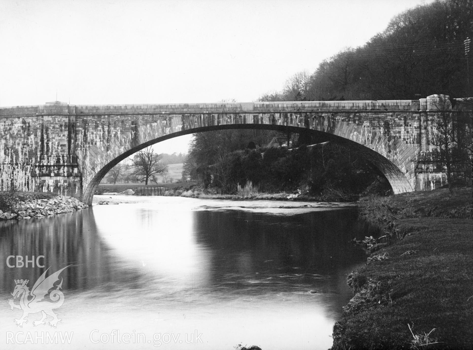 Mounted b&w photographic print showing view of Llandeilo Bridge, Carmarthenshire, originally featured in a volume entitled "British Bridges" published by Public Works, Roads and Transport Congress, 1933.
