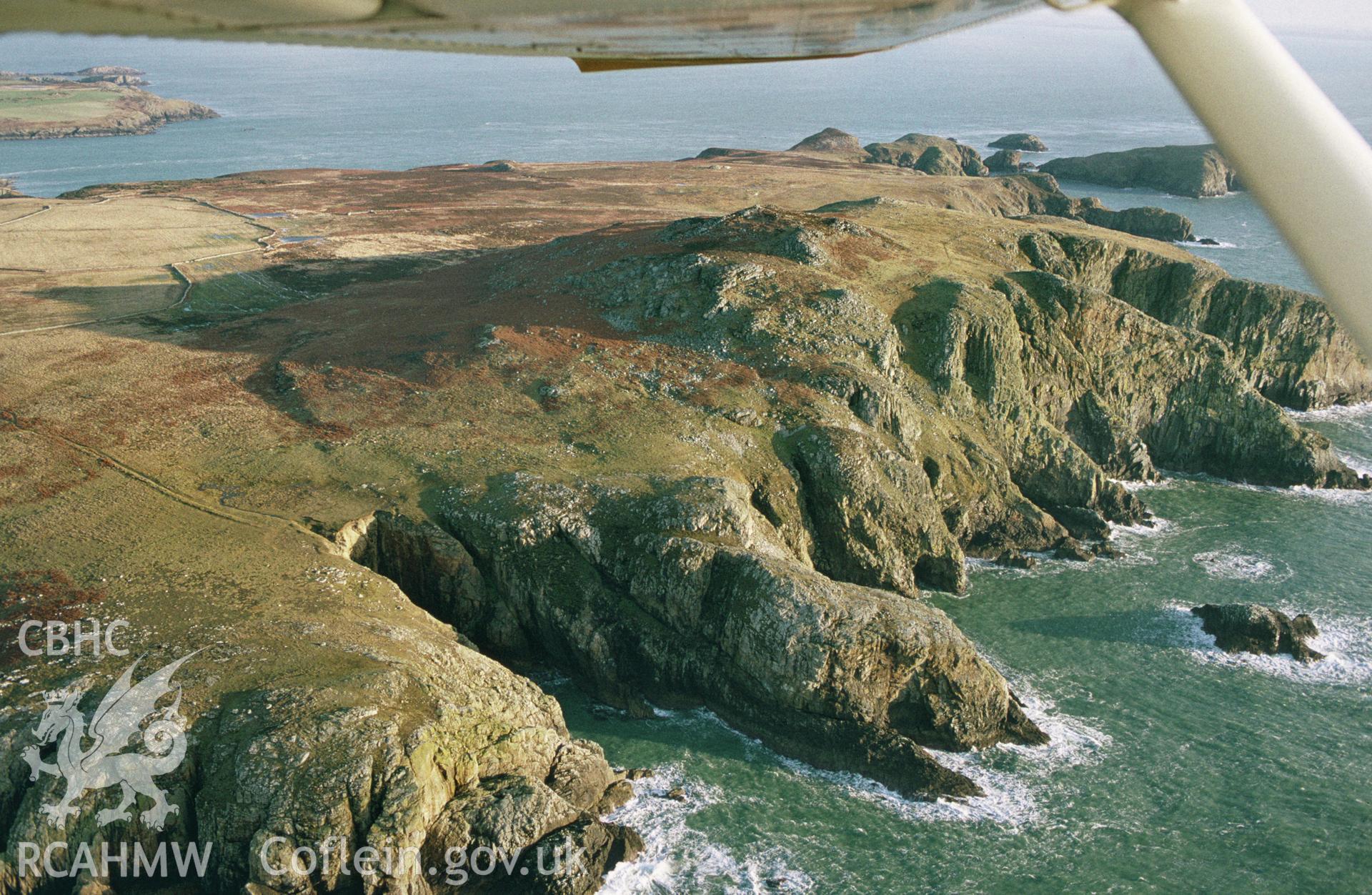 RCAHMW colour slide oblique aerial photograph of reclict field boundary features at Ogiof Colomenod, St Davids and the Cathedral Close, taken by C.R. Musson, 16/01/94