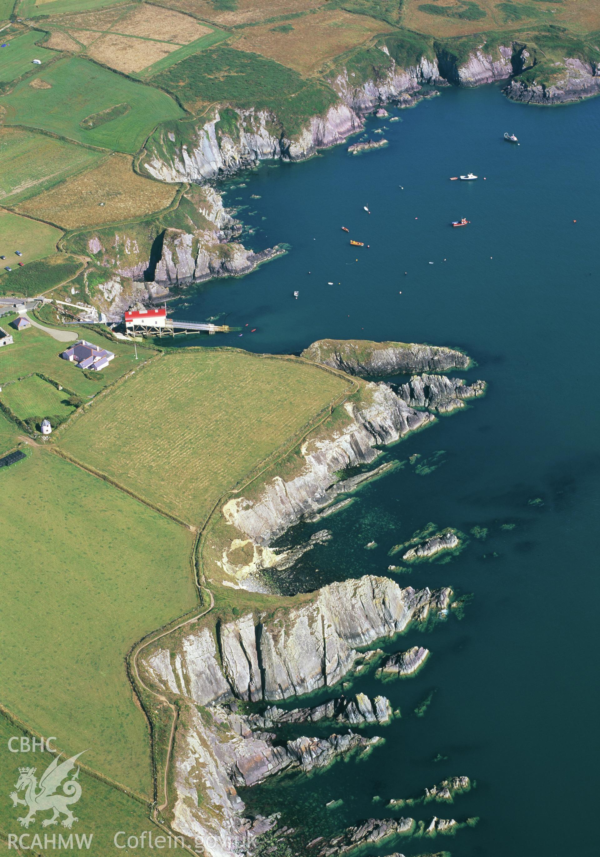 RCAHMW colour oblique aerial photograph of St David's Lifeboat Station and the coastline, taken by Toby Driver, 2002
