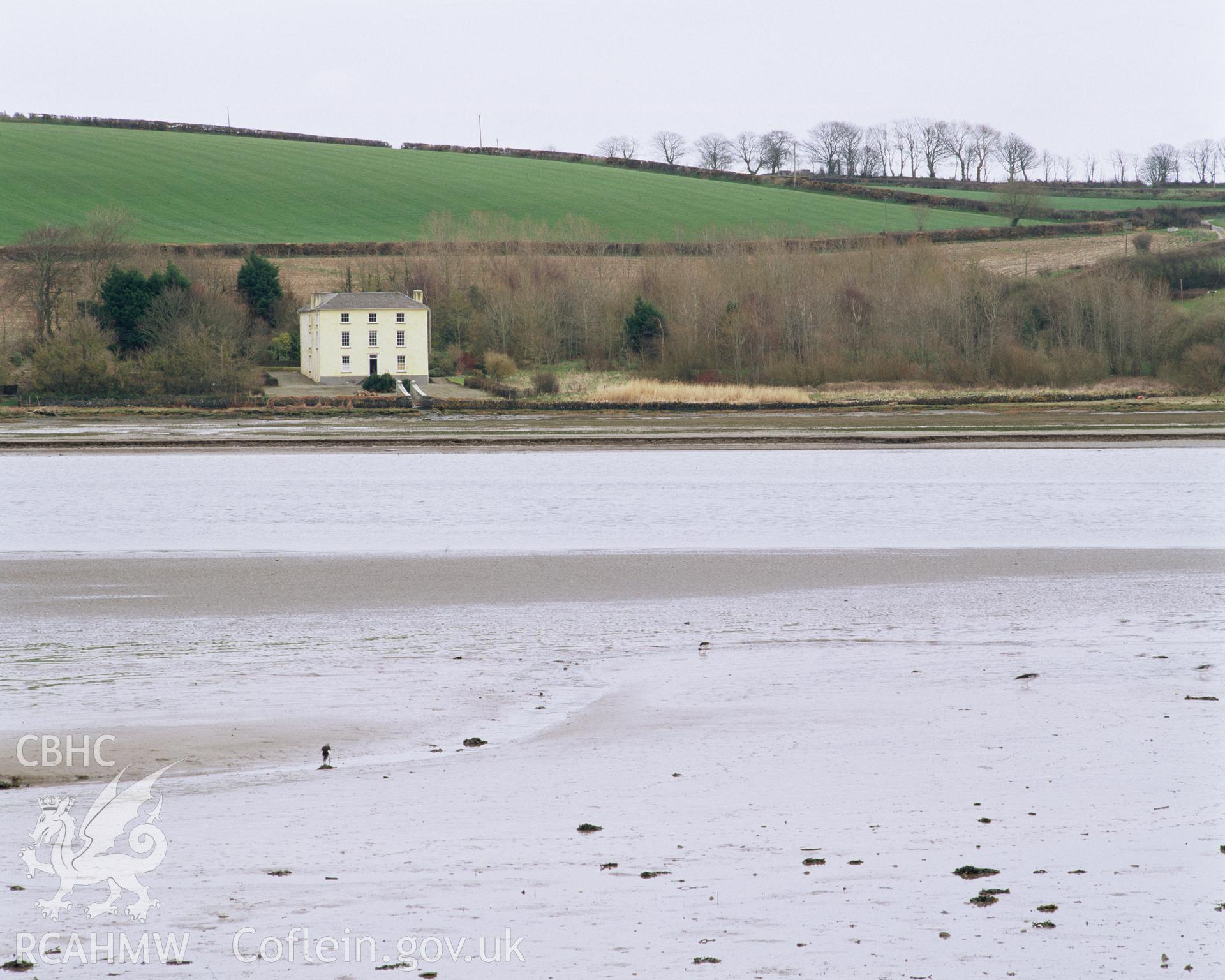 Colour transparency showing an exterior view of Brynymor, Cardigan from across the estuary, produced by Iain Wright, June 2004