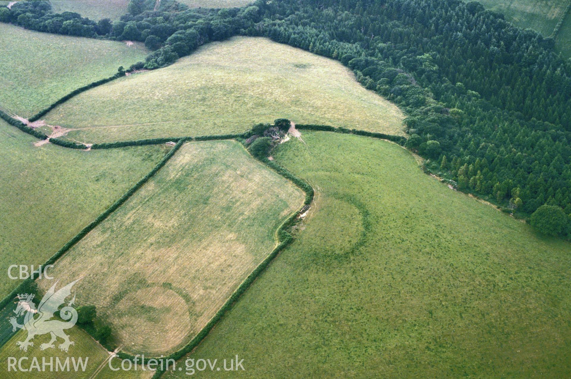 Slide of RCAHMW colour oblique aerial photograph of Dan y Coed Enclosure, Llawhaden, taken by C.R. Musson, 1989.