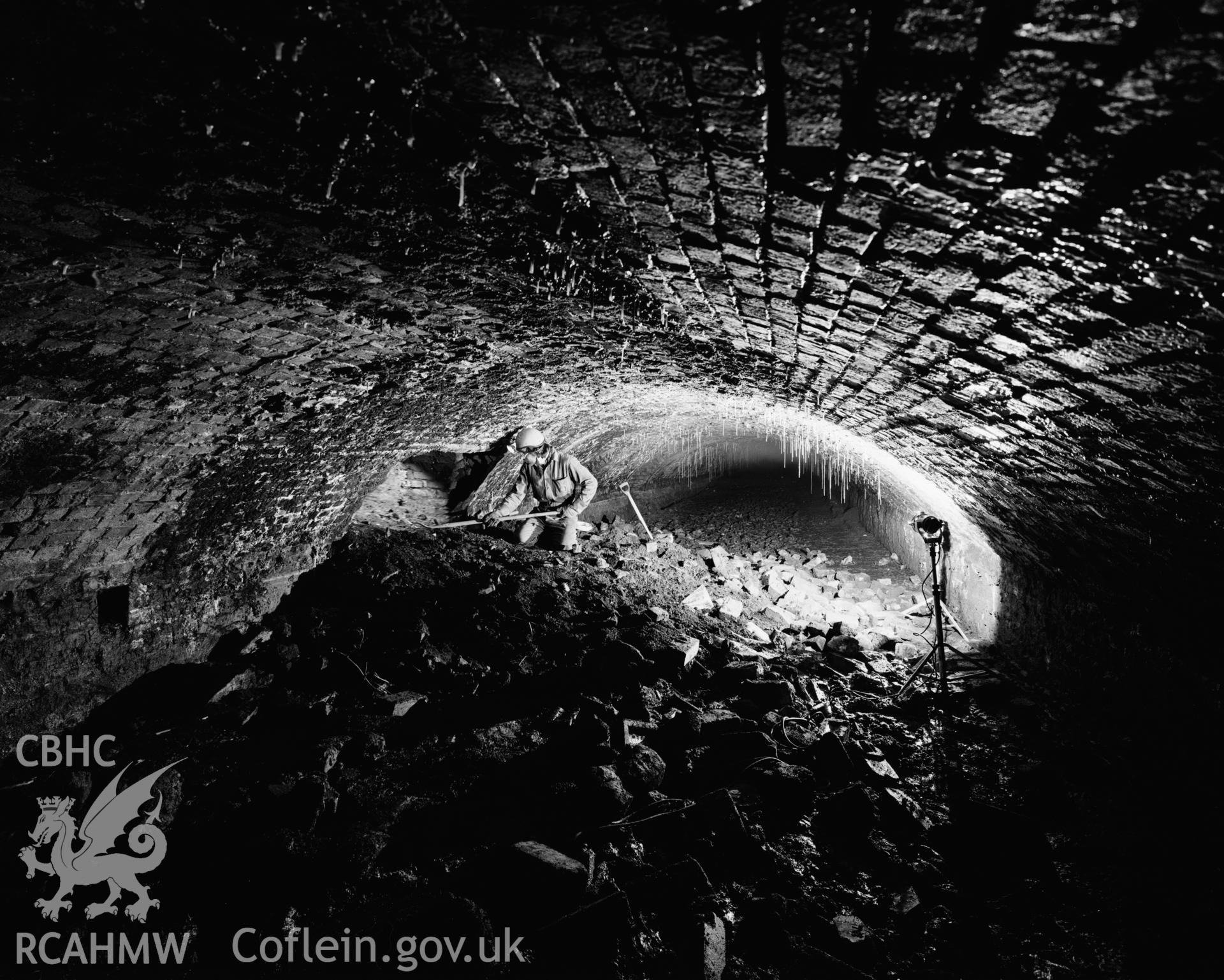 White Rock Tunnel, Smith's Canal Swansea; digitised copy of an RCAHMW black and white negative showing Brian Malaws inside the tunnel, this image has been used in a number of exhibitions and publications including Copperopolis by Stephen Hughes.