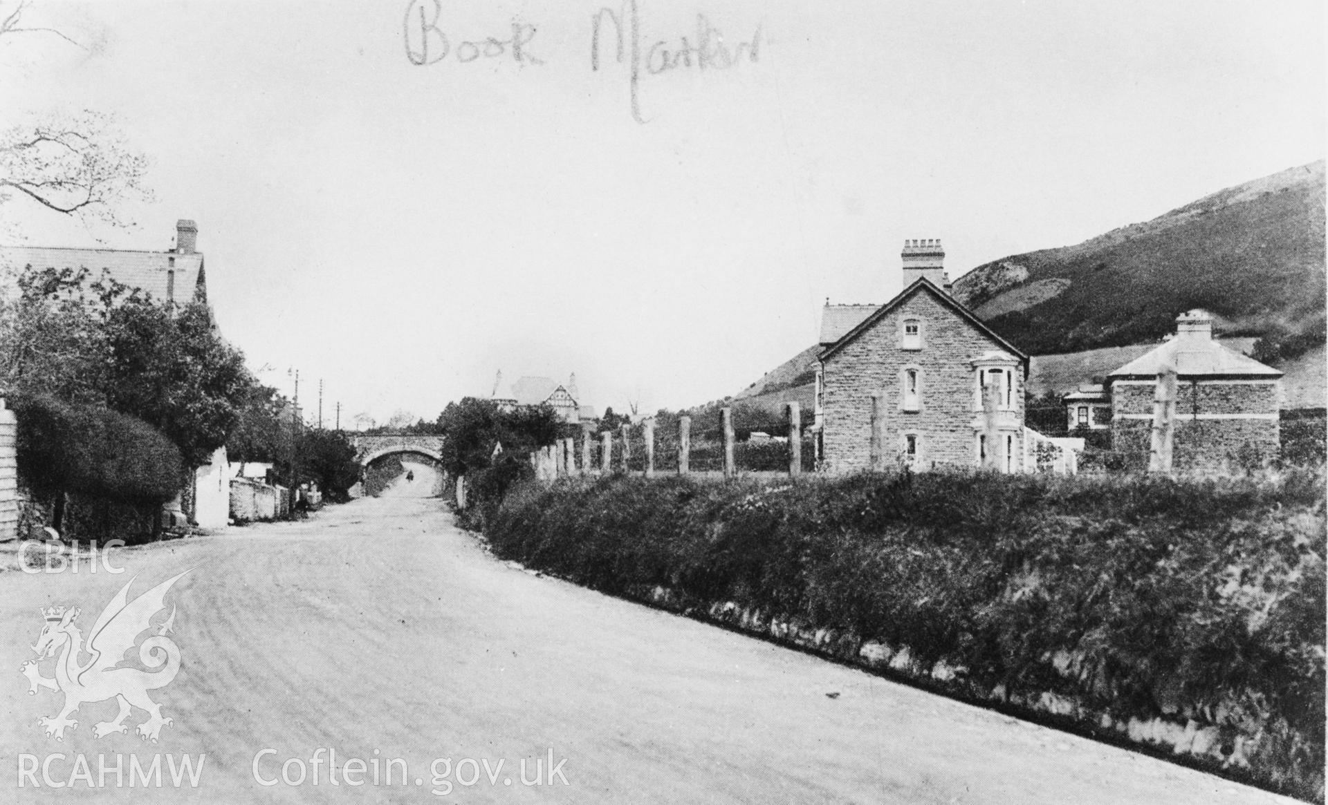 A black and white print of a postcard showing  a view of Llanfarian main road, possibly pre war. Post card loand for copying by Dr C.S.Briggs.