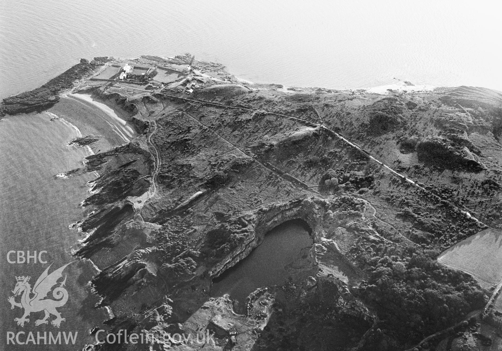 RCAHMW Black and white oblique aerial photograph of Dinmor Park Limestone Quarries, Llangoed, taken on 10/01/1999 by Toby Driver