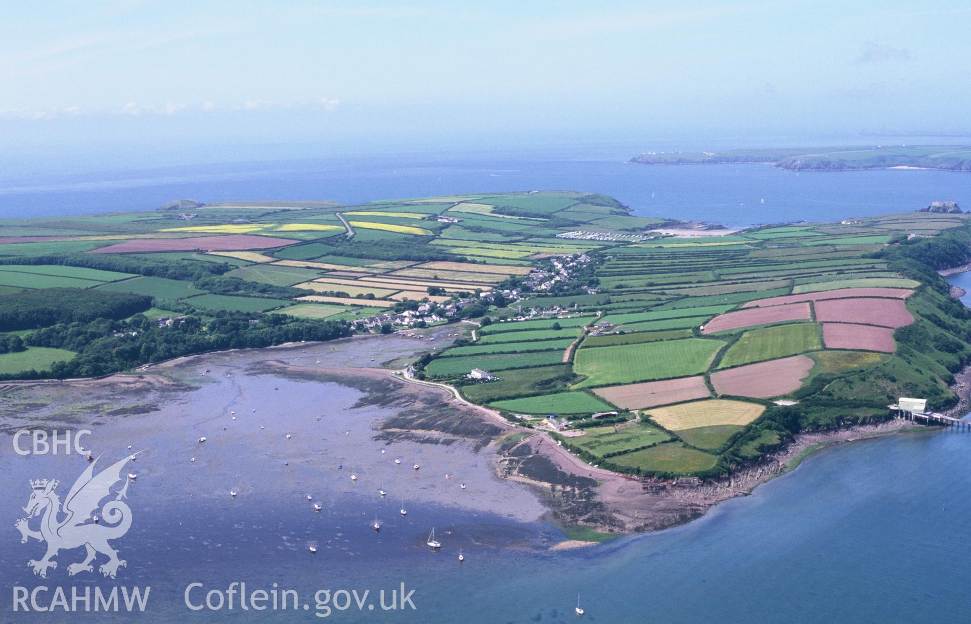 RCAHMW colour oblique aerial photograph of Angle Village, landscape from east with strip fields. Taken by Toby Driver on 13/06/2003
