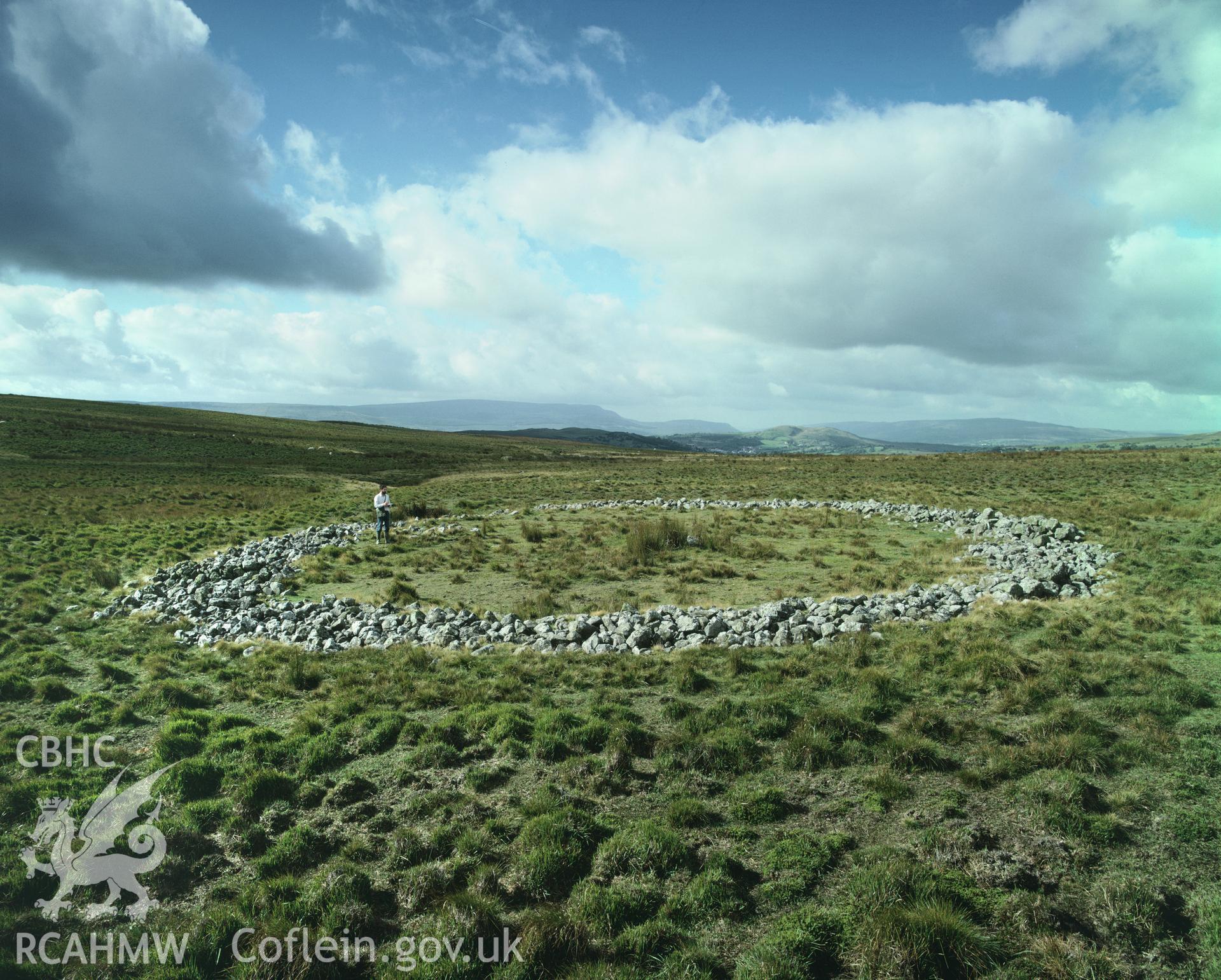 Colour transparency showing a view of Cefn Sychbant Ring Cairn, Hirwaun, produced by Iain Wright, c.1981.