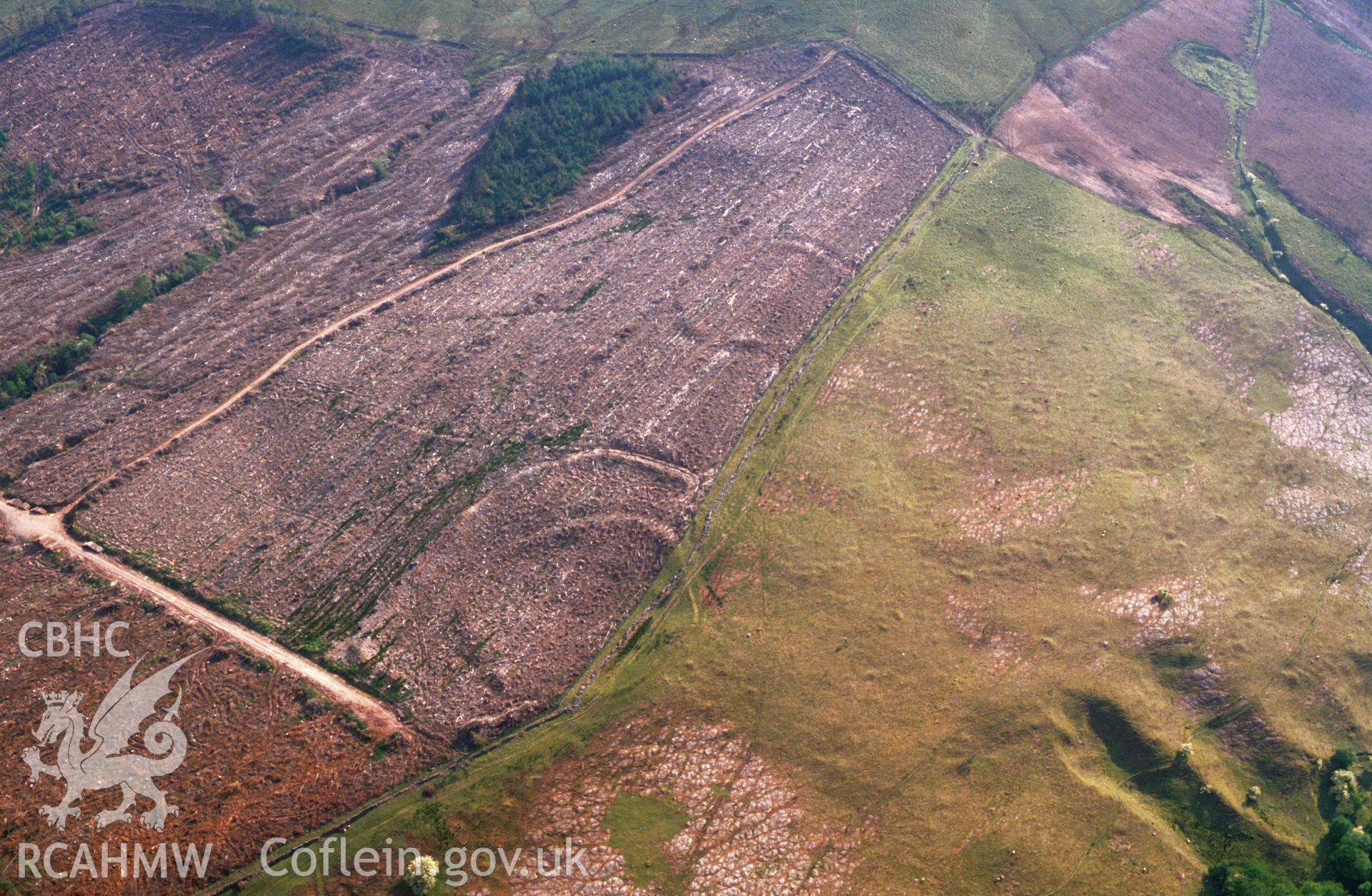 Slide of RCAHMW colour oblique aerial photograph of Nant Tarthwyni Enclosure, Talybont on Usk taken by C.R. Musson, 1990.