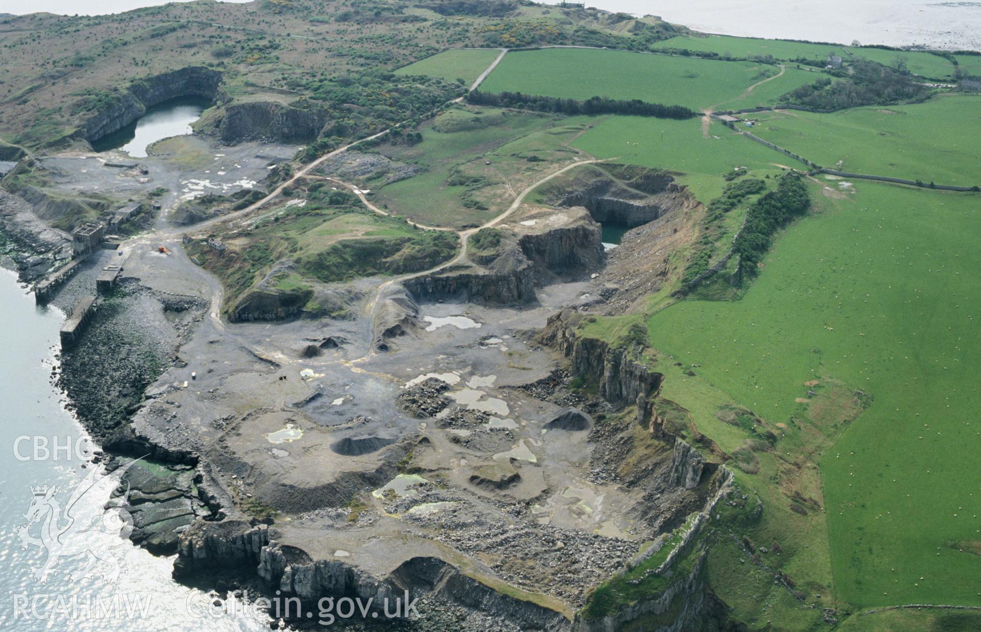 RCAHMW colour slide oblique aerial photograph of Dinmor Park Limestone Quarries (disused), Llangoed, taken by C.R. Musson, 01/05/94