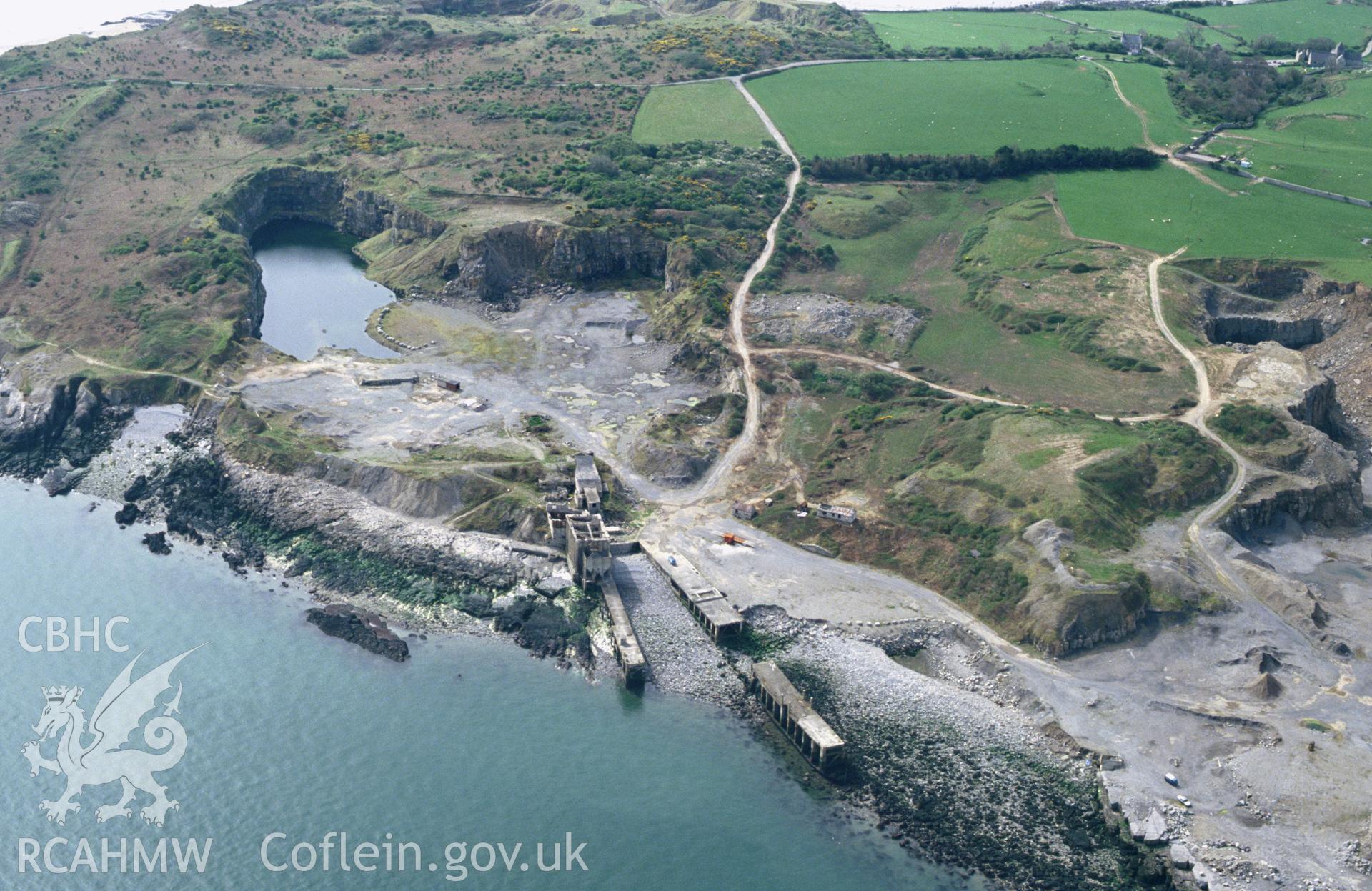 RCAHMW colour slide oblique aerial photograph of Dinmor Park Limestone Quarries (disused), Llangoed, taken by C.R. Musson, 01/05/94