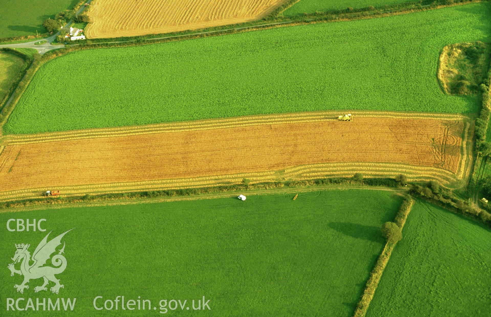 RCAHMW colour oblique aerial photograph of Post-coch, enclosure, soilmark. Taken by Toby Driver 2002