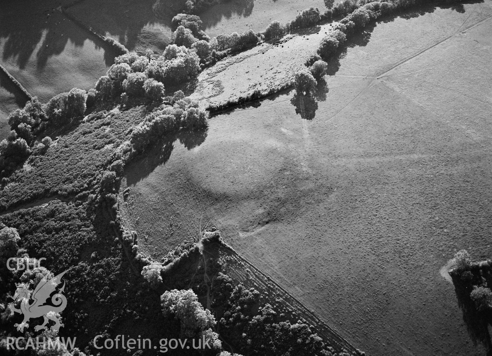 RCAHMW black and white oblique aerial photograph of Gaer Enclosure, taken by C R Musson, 15/07/1996.