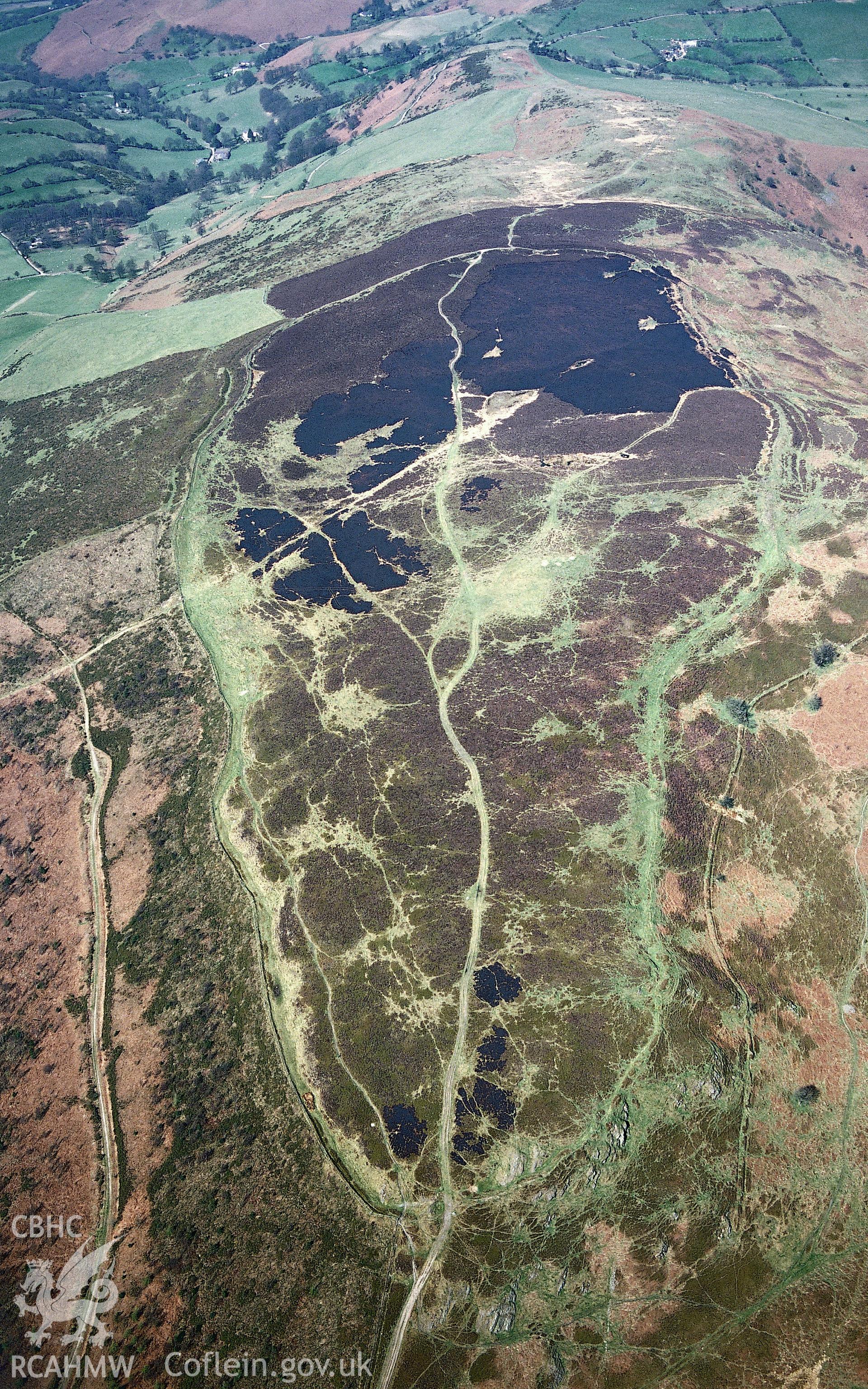 RCAHMW colour slide aerial photograph of Penycloddiau, hillfort, following bracken burn off, from southeast. Taken by Toby Driver on 08/04/2003.