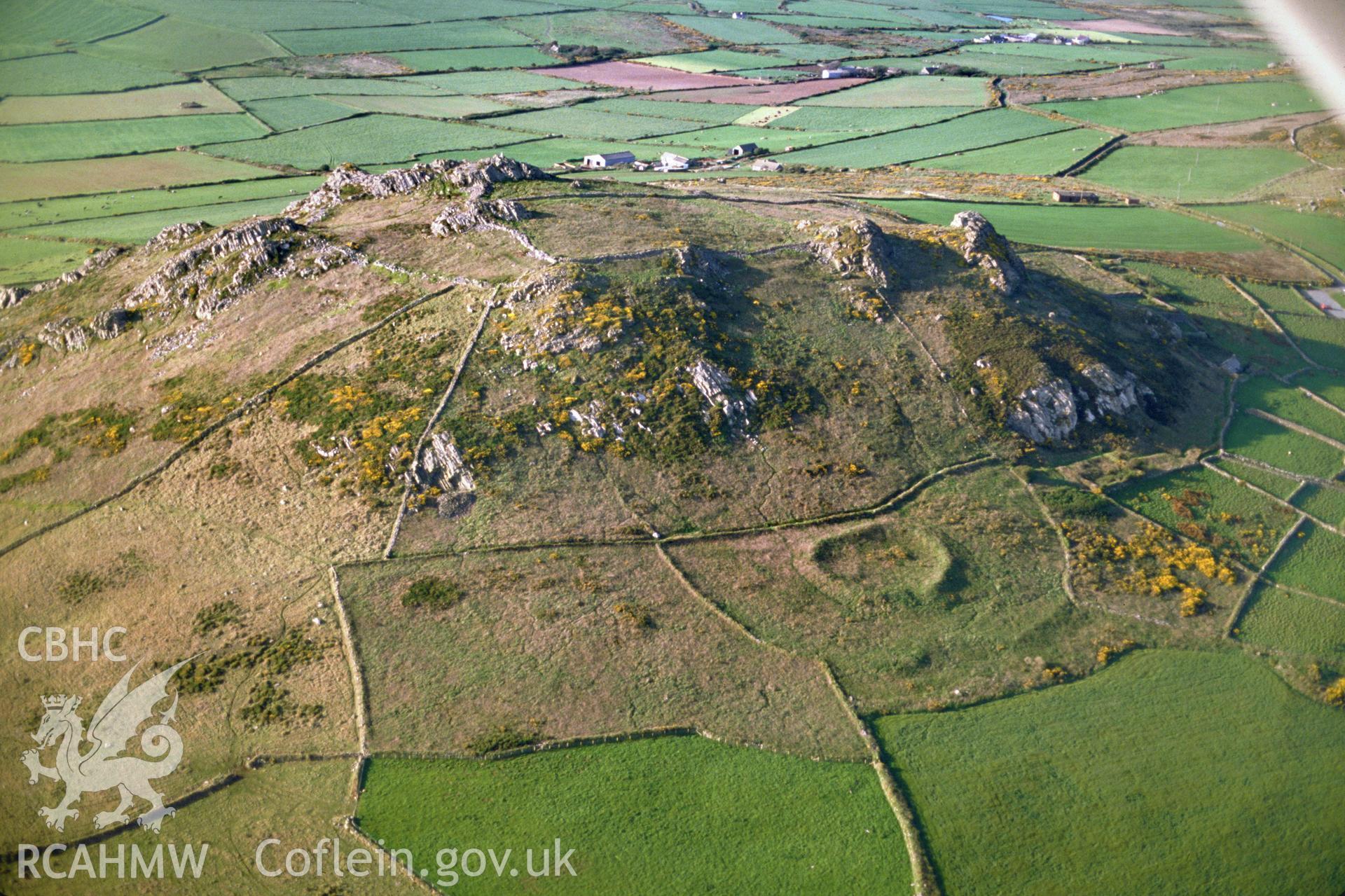 Slide of RCAHMW colour oblique aerial photograph of Ysgubor Gaer, Pencaer, taken by C.R. Musson, 1989.