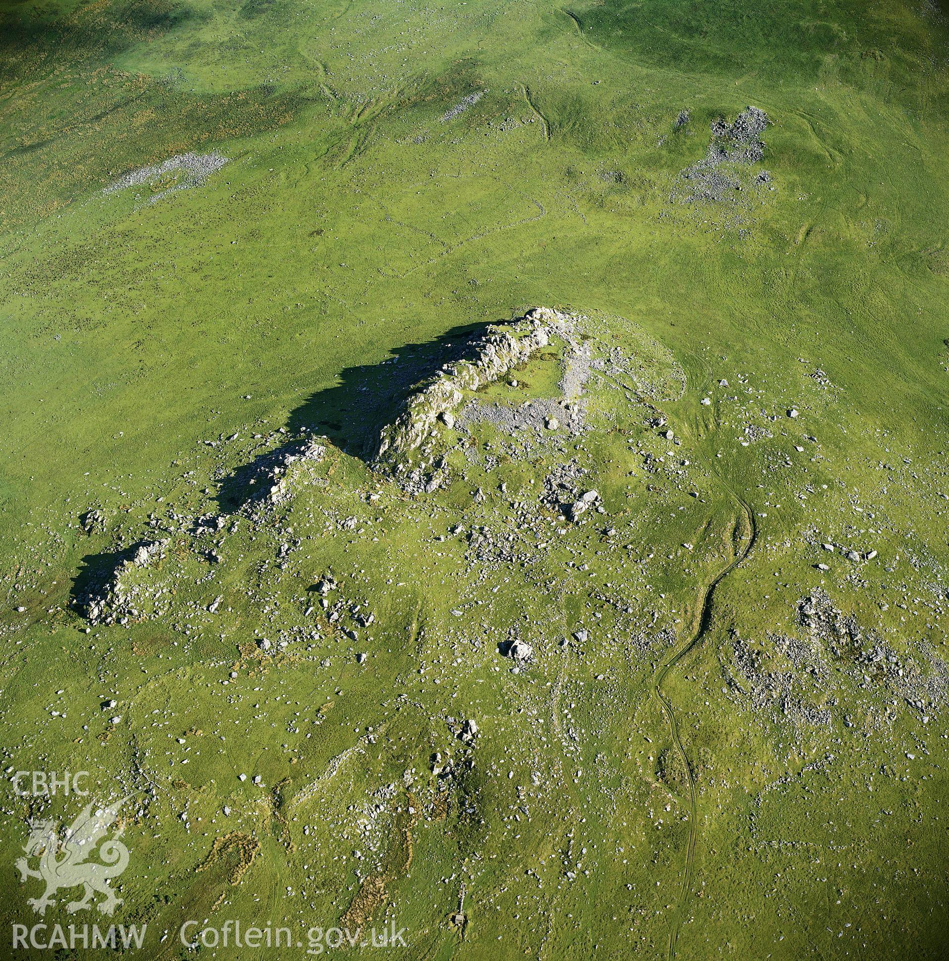 RCAHMW black and white oblique aerial photograph of Carn Alw Hillfort, taken by C R Musson, 1990.