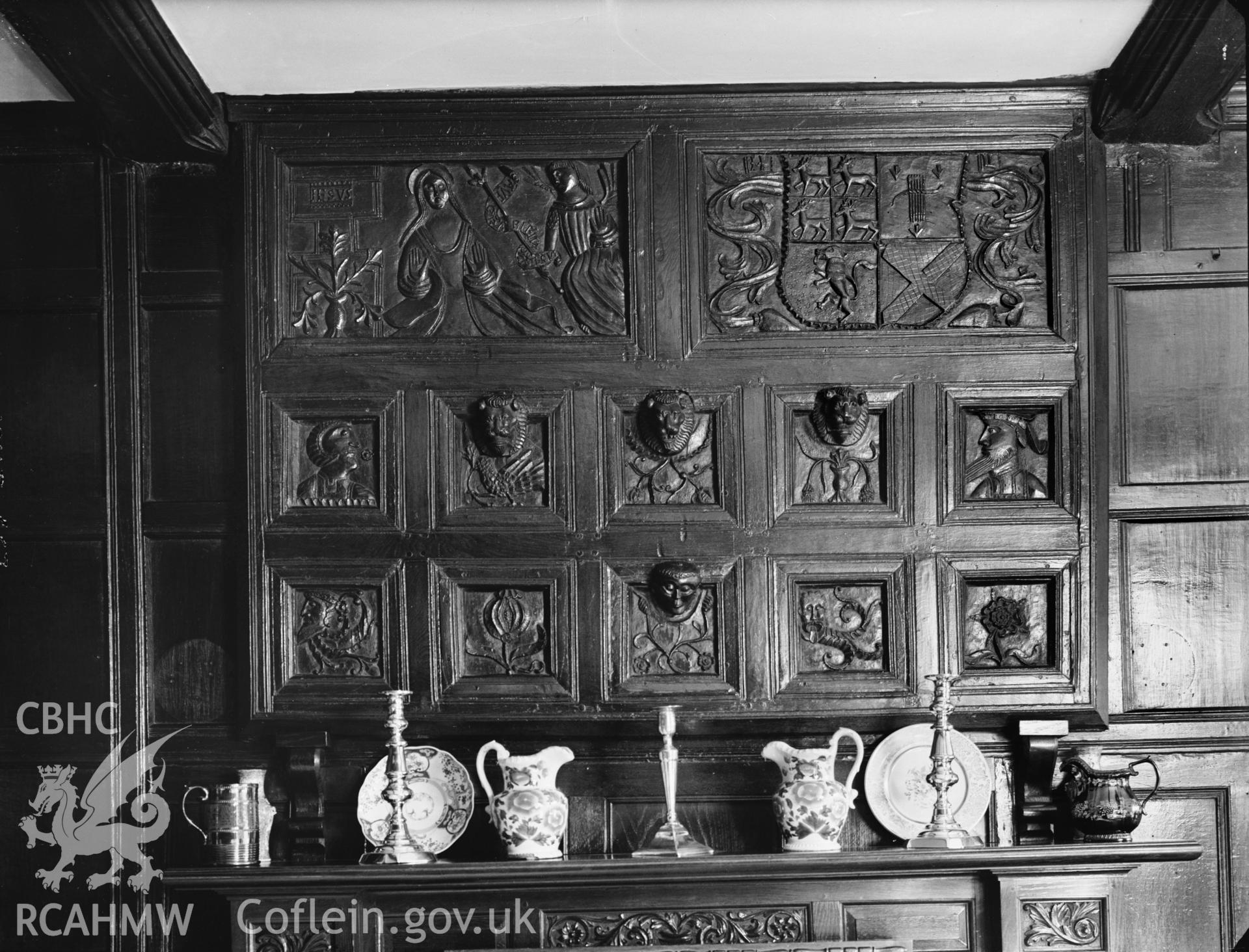 Carved panels over fireplace