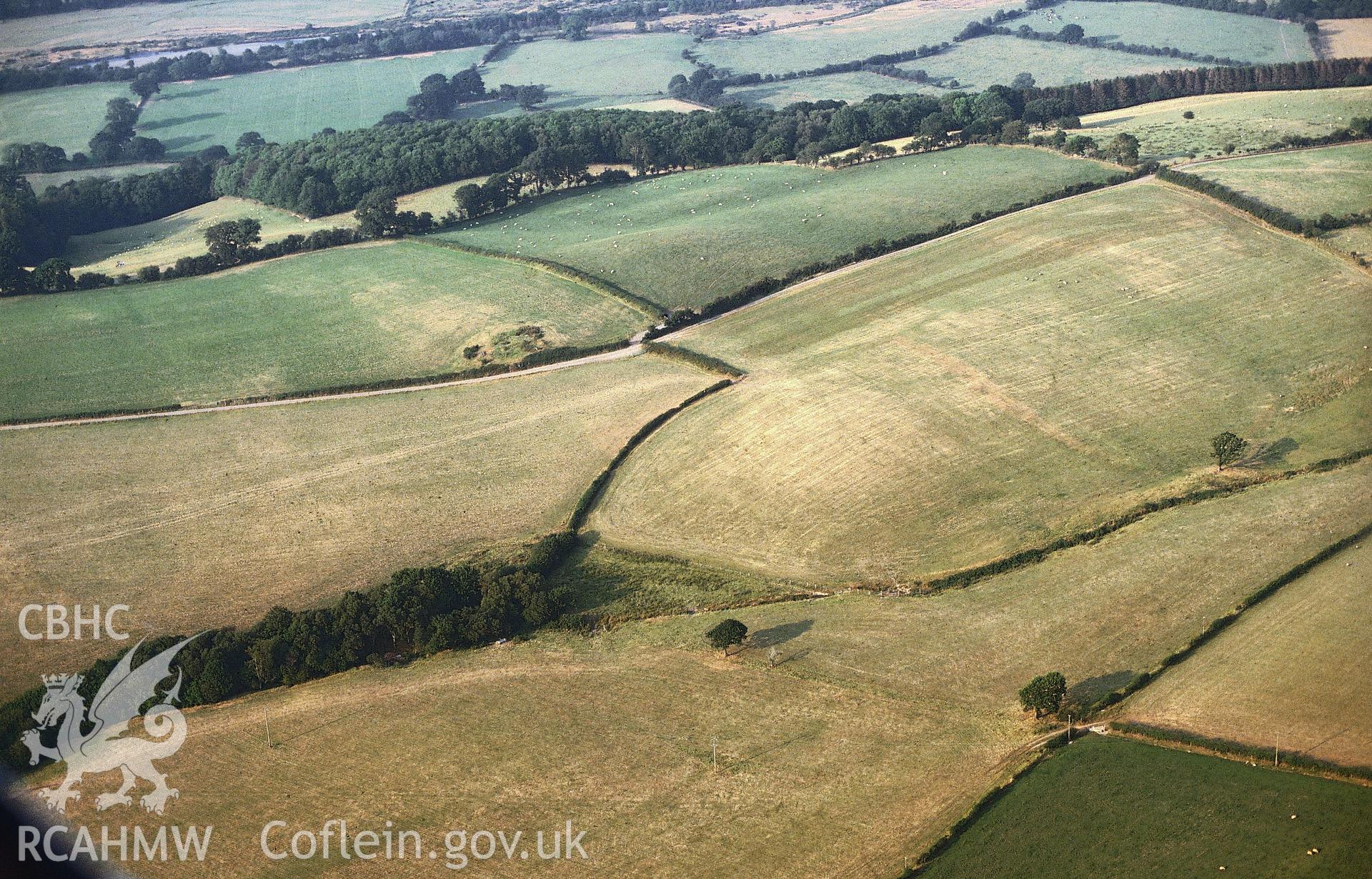 Slide of RCAHMW colour oblique aerial photograph of cropmarks at Berth-lwyd, Llanilar, taken by C.R. Musson, 1990.