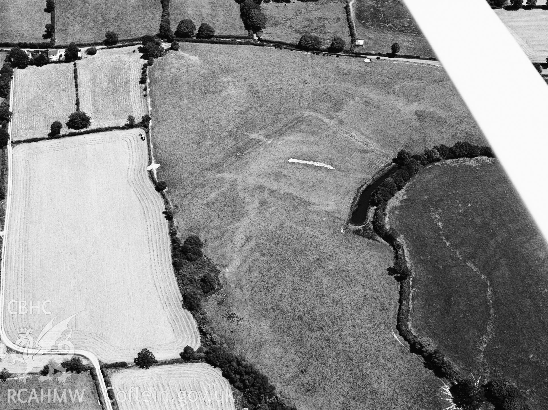 RCAHMW black and white oblique aerial photograph of cropmarks at Llwyn Bwch, taken 2003.