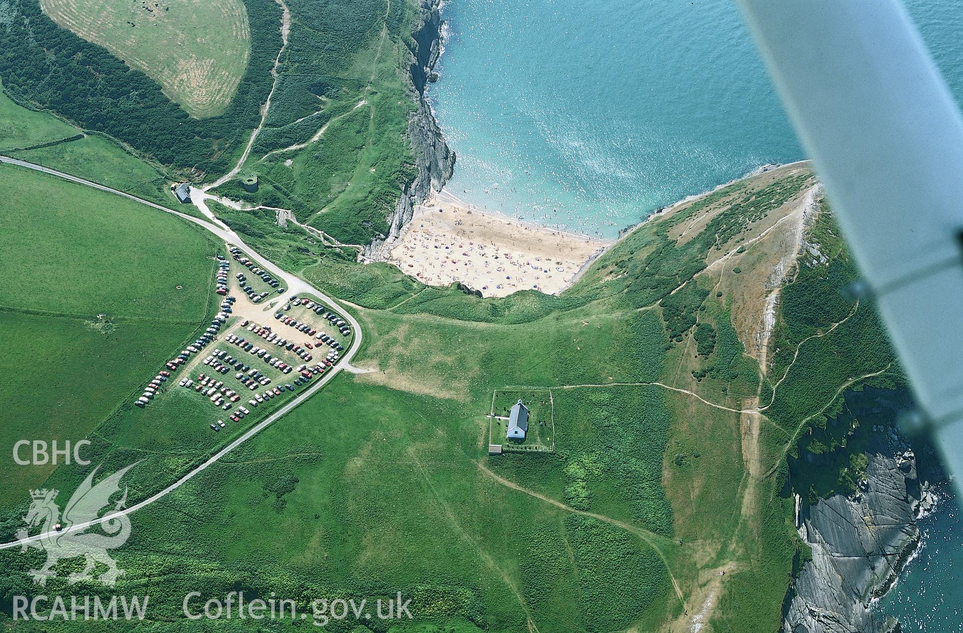 RCAHMW colour oblique aerial photograph of Holy Cross Church, Mwnt Verwig taken on 05/08/2002 by Toby Driver