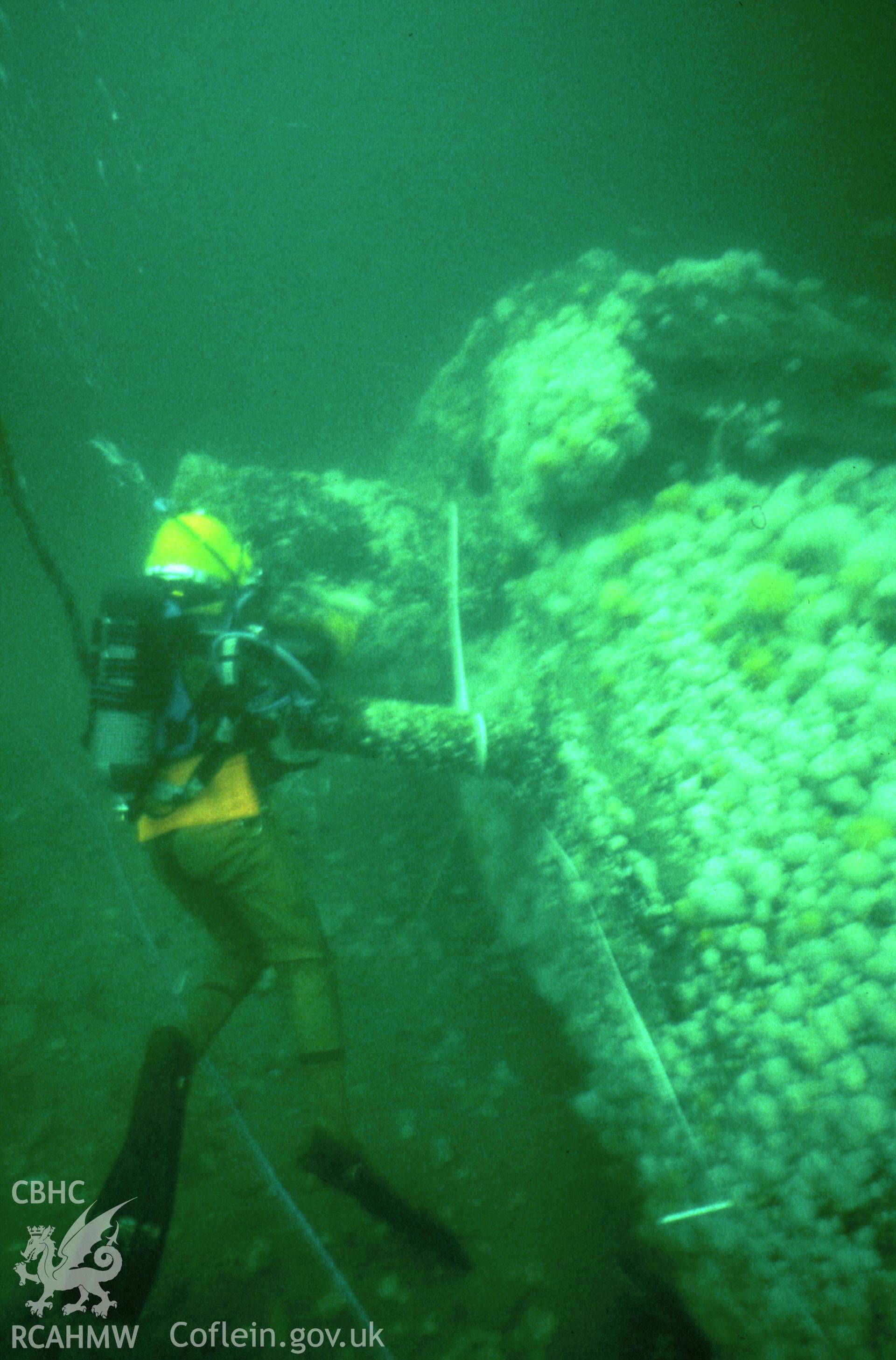 Colour slide. ADU diver moving forward along the top of RESURGAM, hand resting on exhaust port.