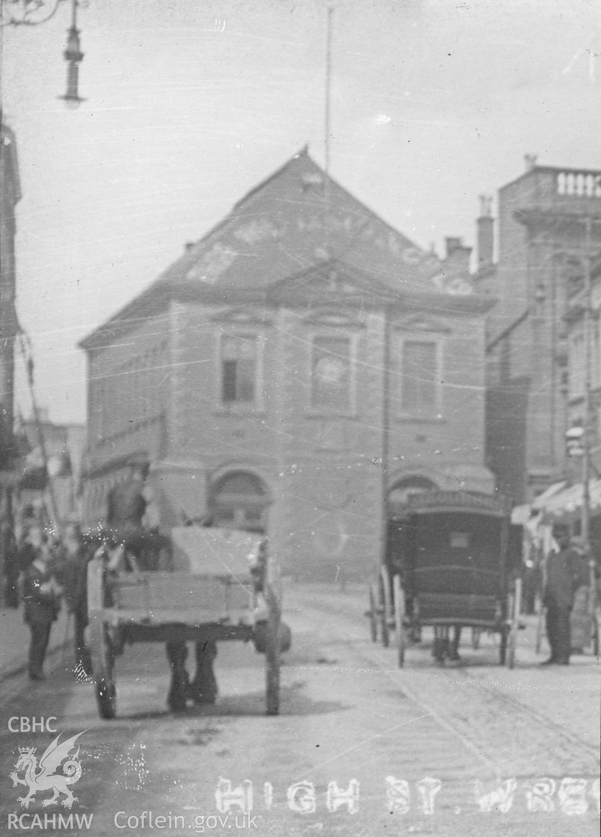 Early image of Wrexham Old Town Hall, with horse and cart and carriages in the foreground.