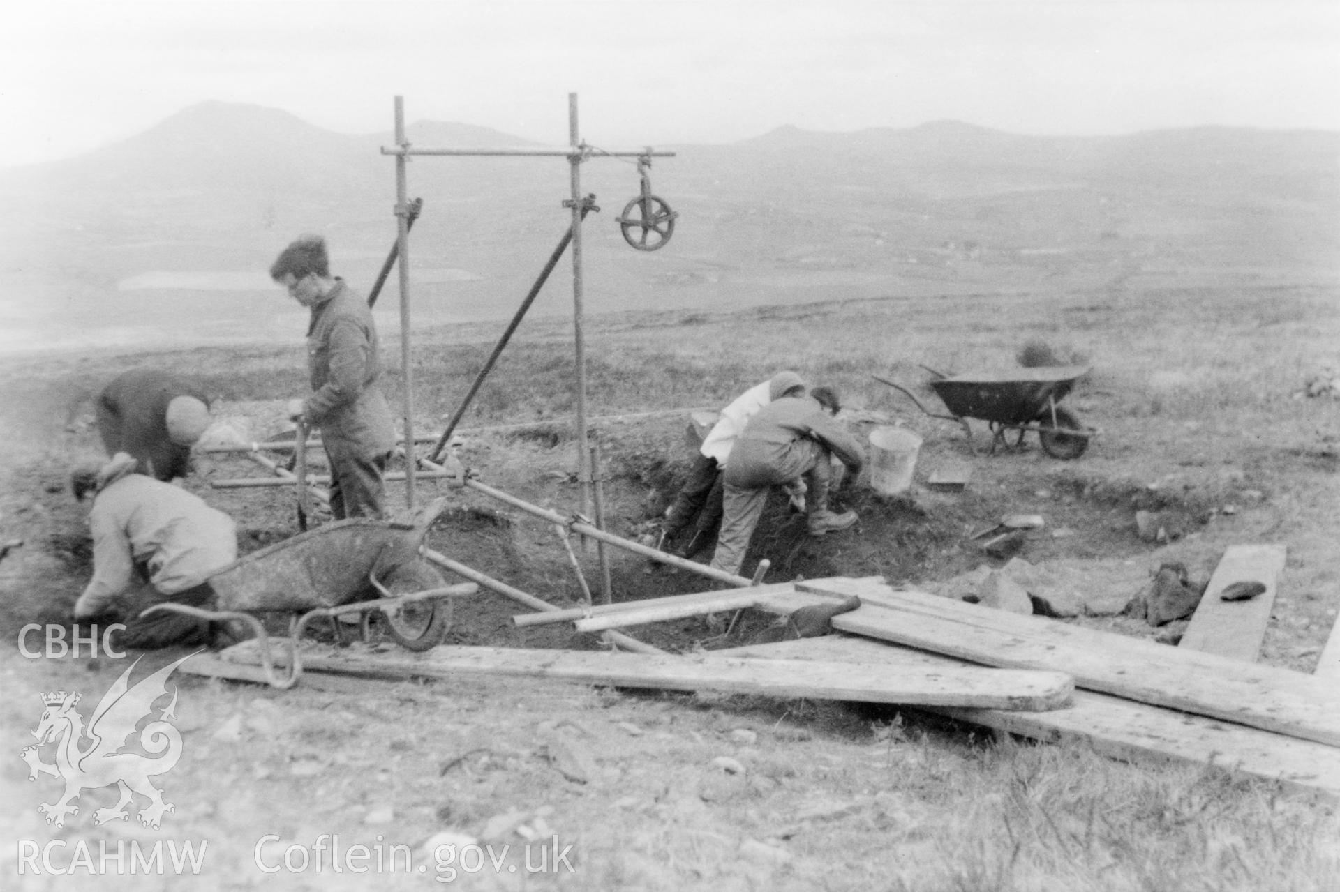 Neolithic Axe Factory, Mynydd Rhiw, Caernarvonshire; black and white photograph taken during the 1959 excavations, showing general activity around the centre pit.