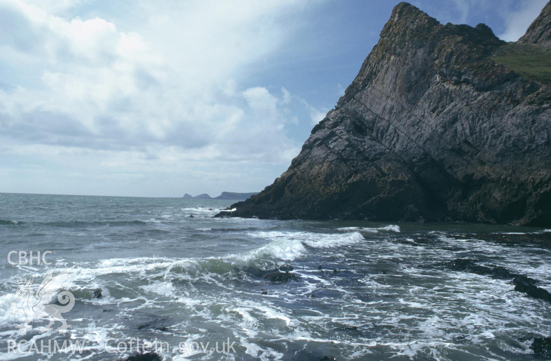 Goat's Hole Cave Paviland; colour slide showing view along coast to Worms Head, taken by David Leighton, 1997.