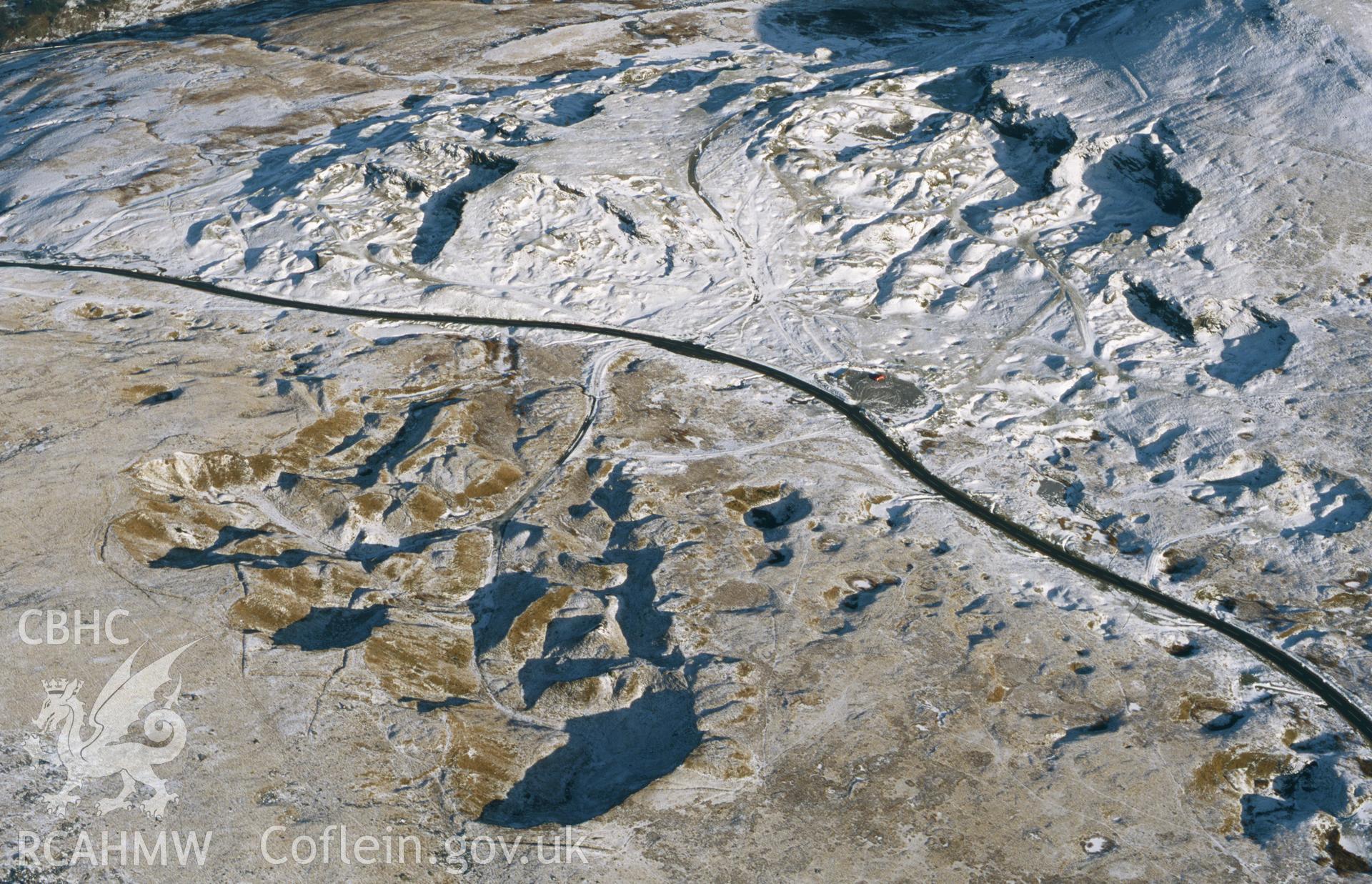 RCAHMW colour oblique aerial photograph of Foel Fawr, quarry complex, under snow, from W. Taken by Toby Driver on 10/01/2003