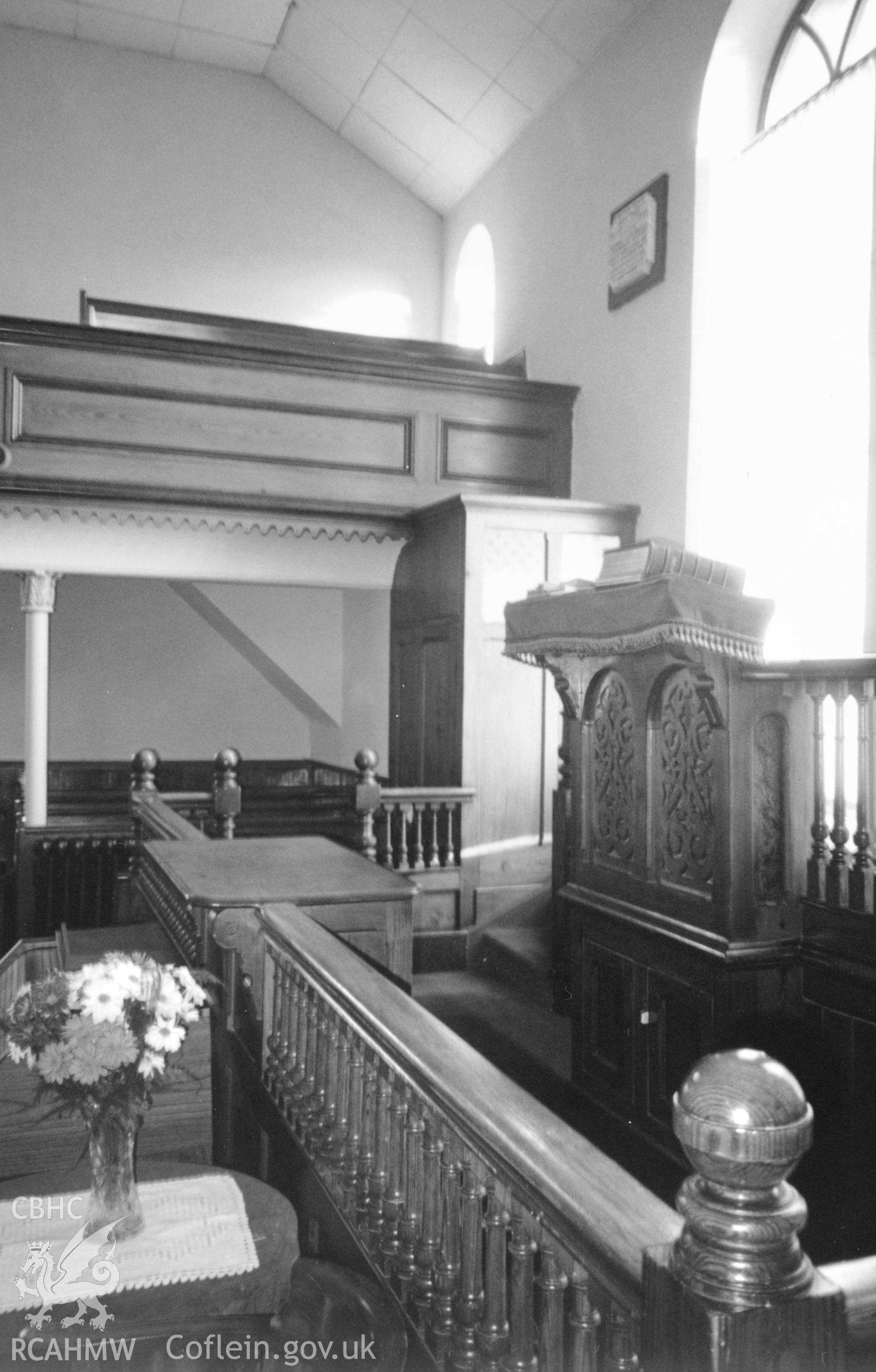 Digital copy of a black and white photograph showing an interior view of Cross Inn Welsh Calvinistic Methodist Chapel,  Court Henry, taken by Robert Scourfield, c.1996.