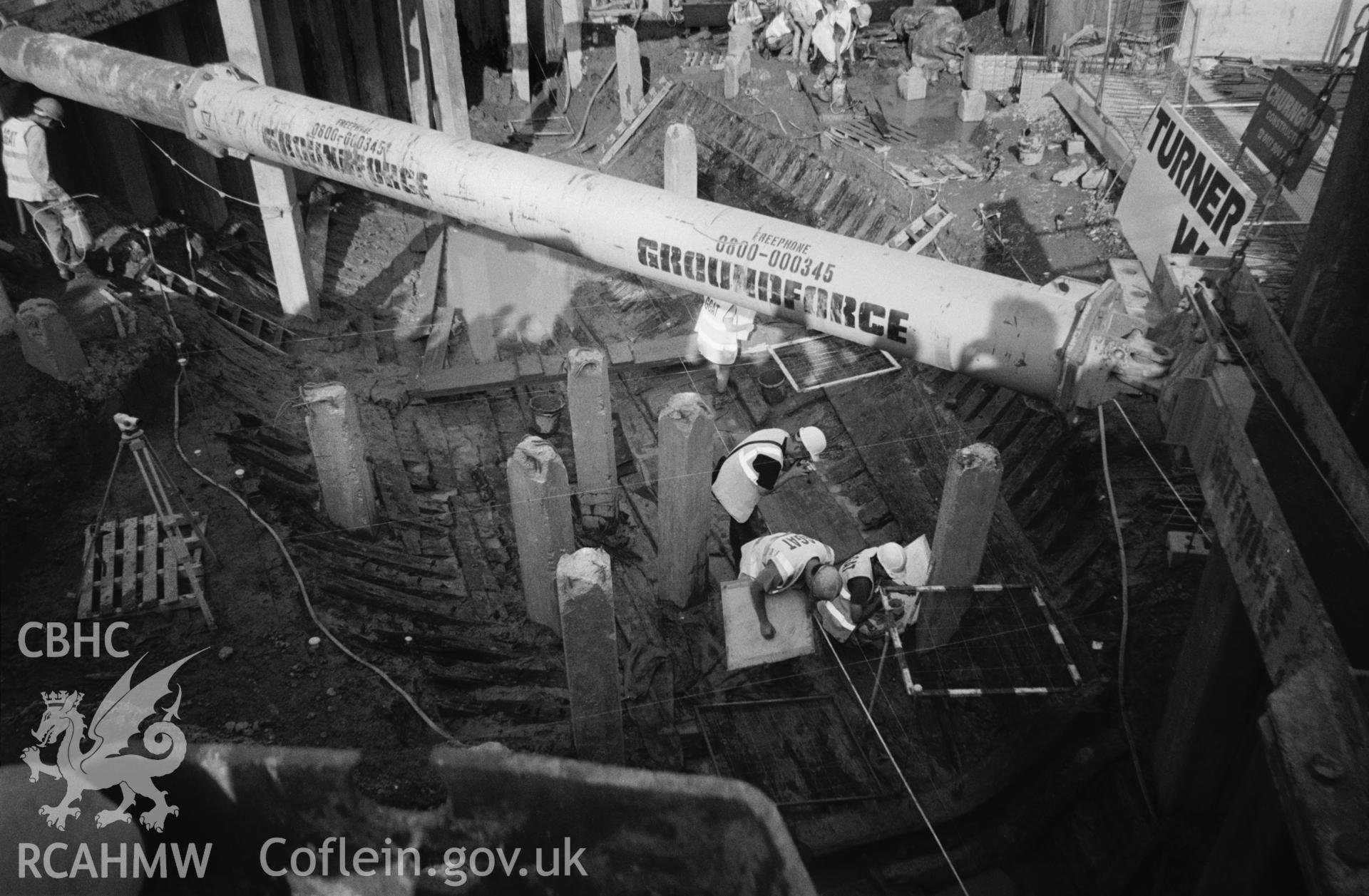 Excavation - general view towards bow, with heavy internal framing timbers in foreground.